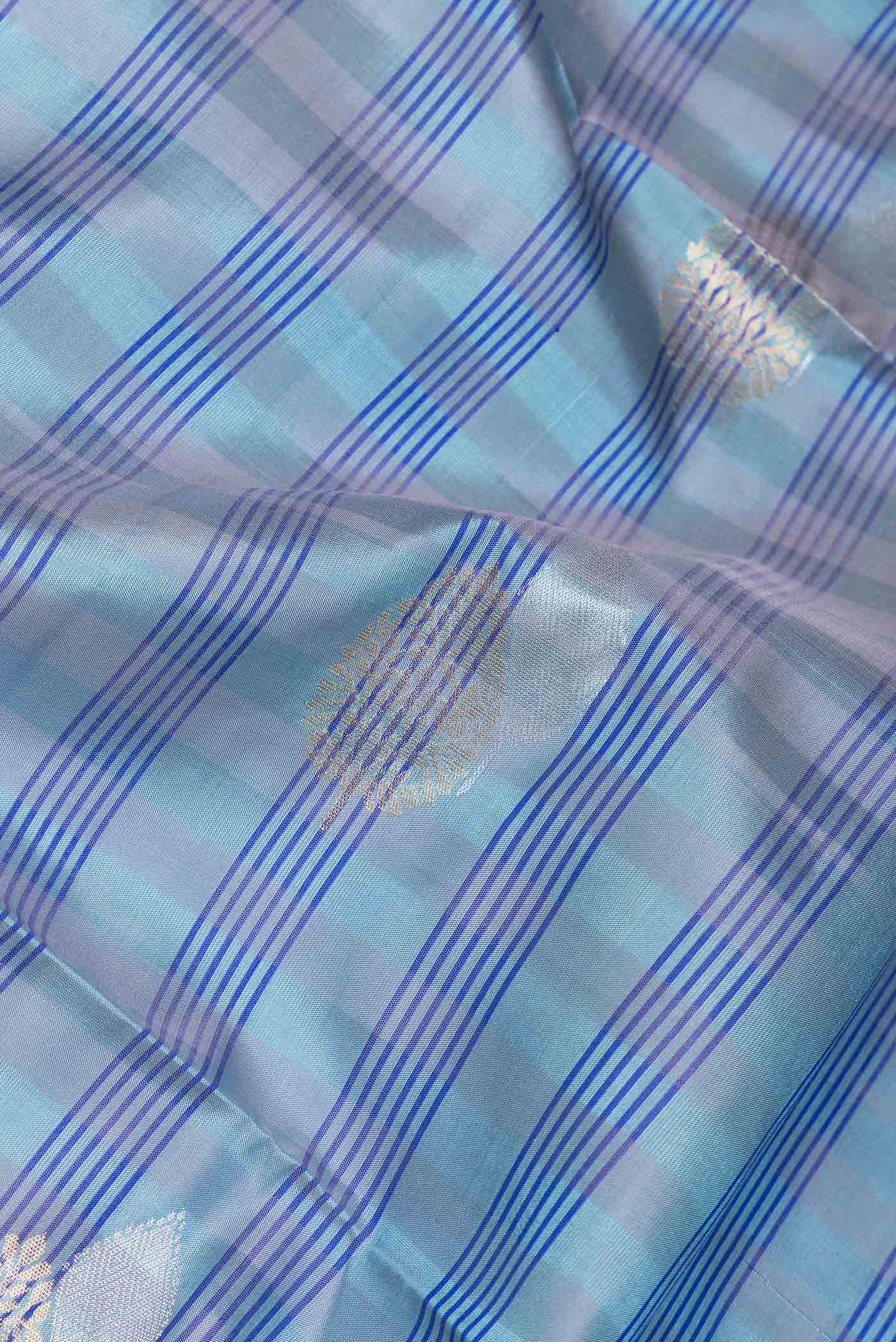 Close up of Sky Blue Dual Tone Soft Silk Saree with Checked design on the body and Without Border.  displaying folds