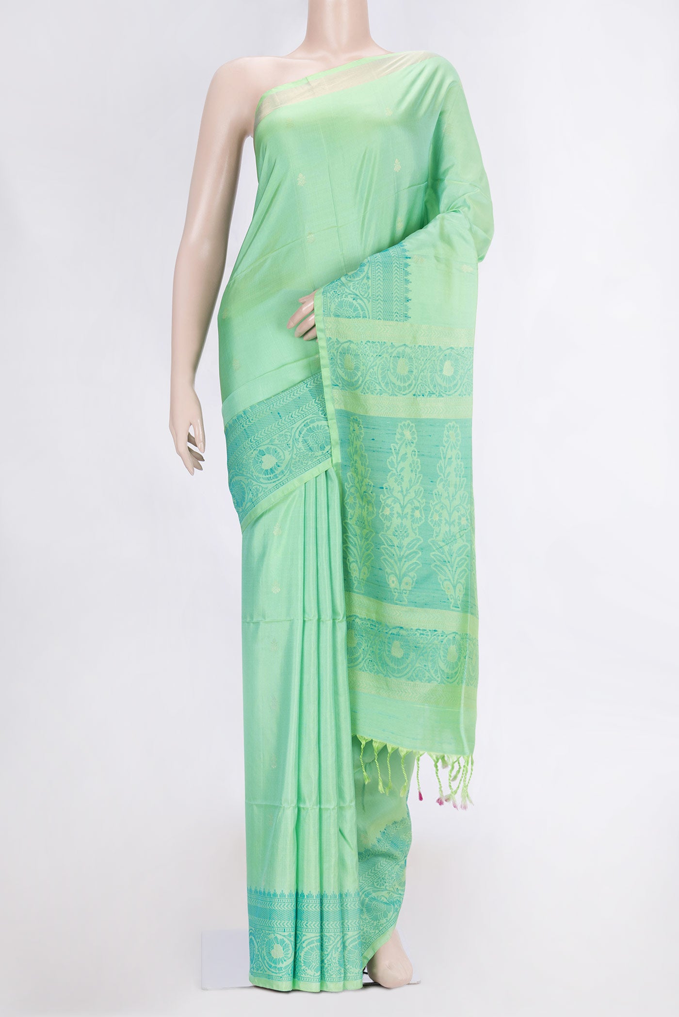 Pista Green Dual Tone Soft Silk Saree with Zari Butta on the body and Zari And Thread Border.  displayed on a mannequin