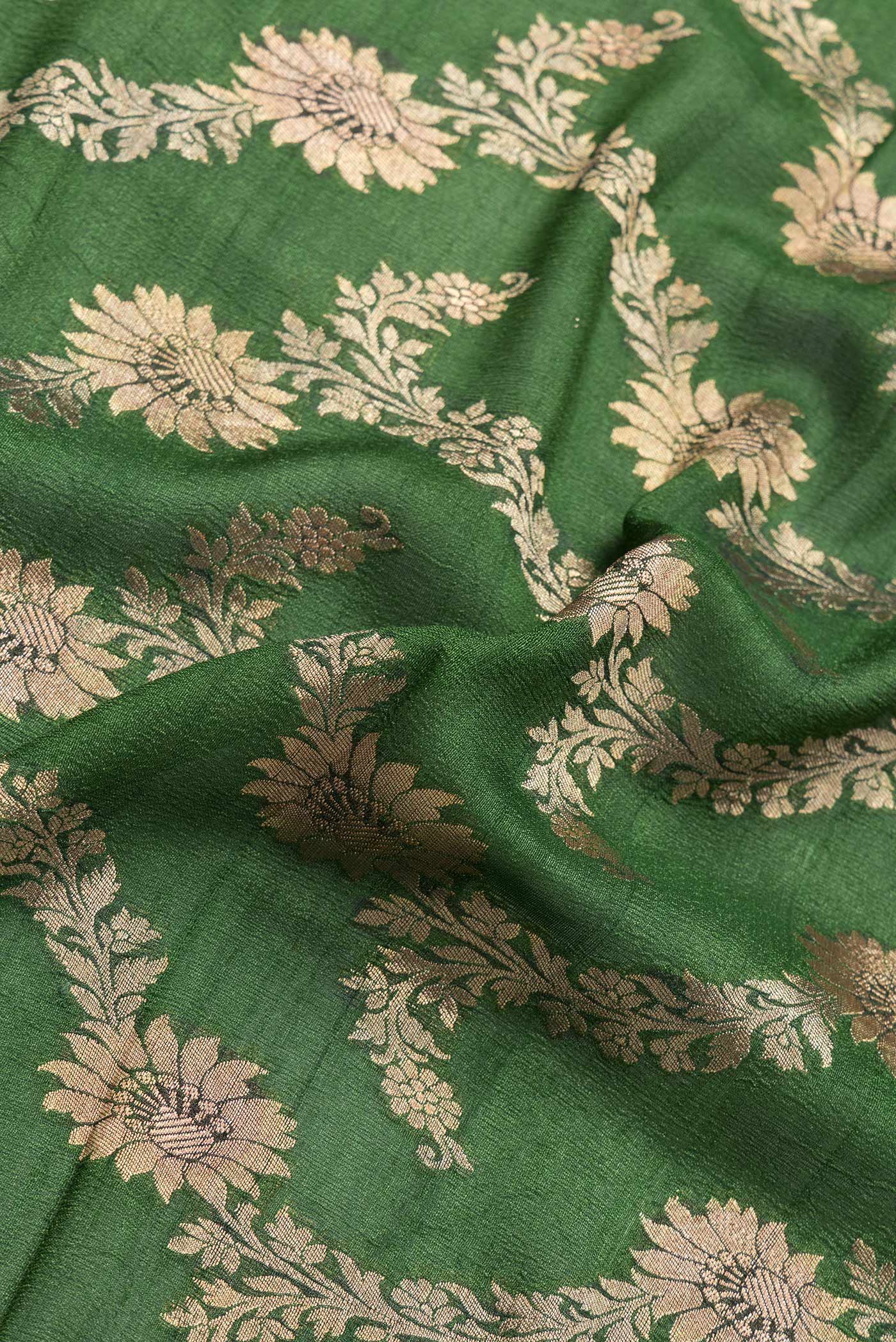 Close up of Bottle Green Dual Tone Tussar Silk Saree with Zari Brocade on the body and Zari Border.  displaying folds