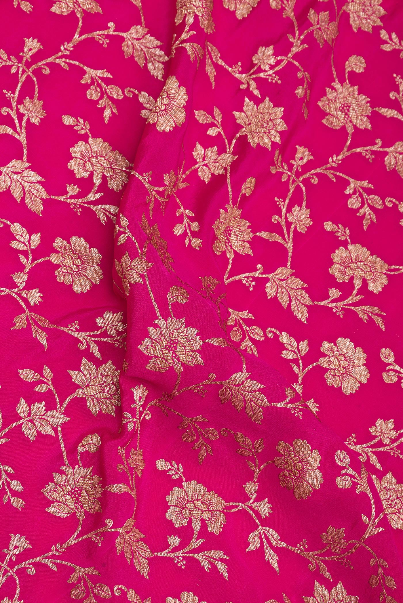 Close up of Magenta Banarasi Georgette Saree with Zari Brocade on the body and Zari Border.  displaying folds