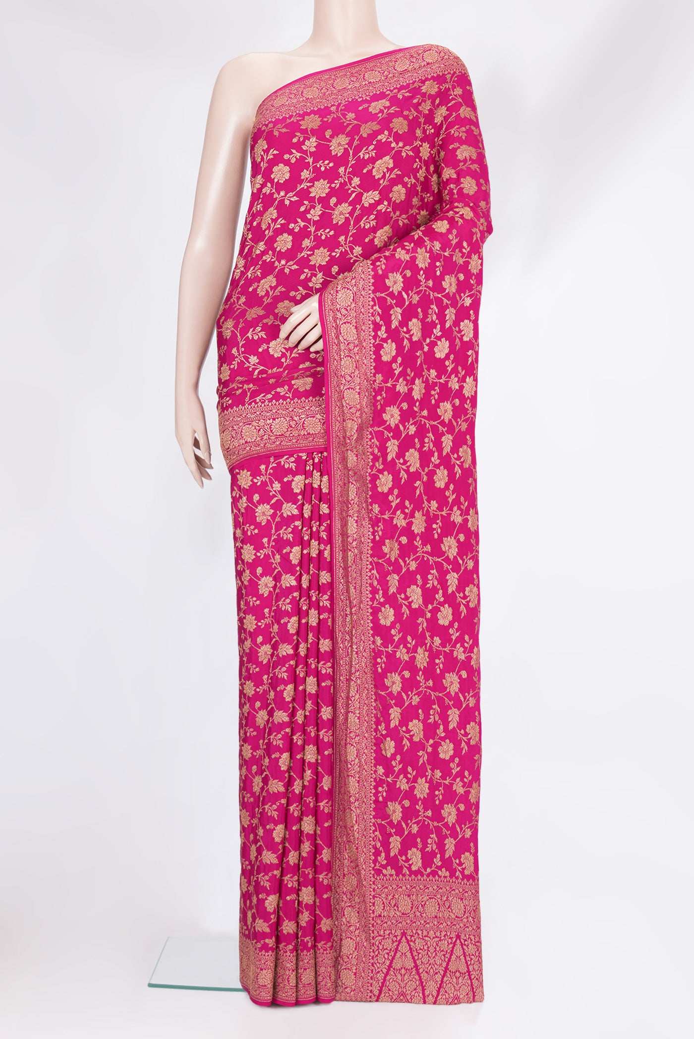 Magenta Banarasi Georgette Saree with Zari Brocade on the body and Zari Border.  displayed on a mannequin