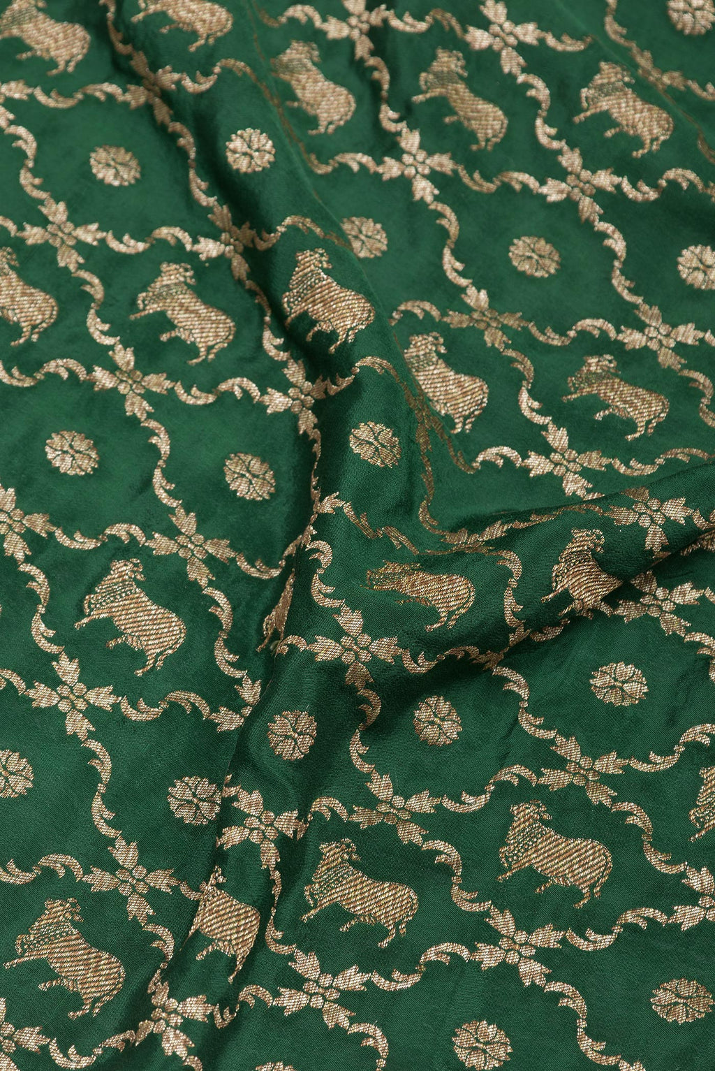 Close up of Bottle Green Banarasi Georgette Saree with Zari Brocade on the body and Zari Border.  displaying folds