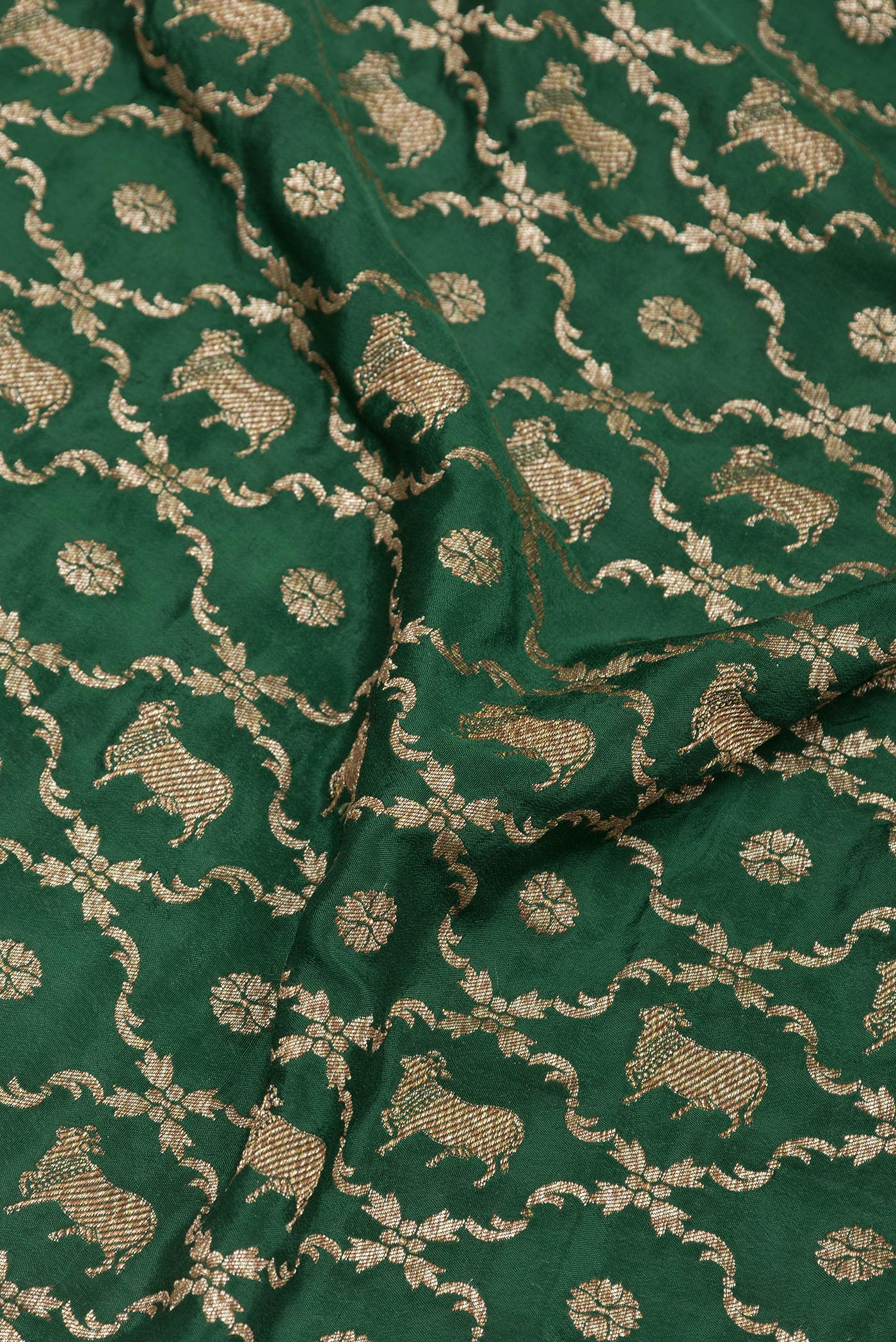 Close up of Bottle Green Banarasi Georgette Saree with Zari Brocade on the body and Zari Border.  displaying folds