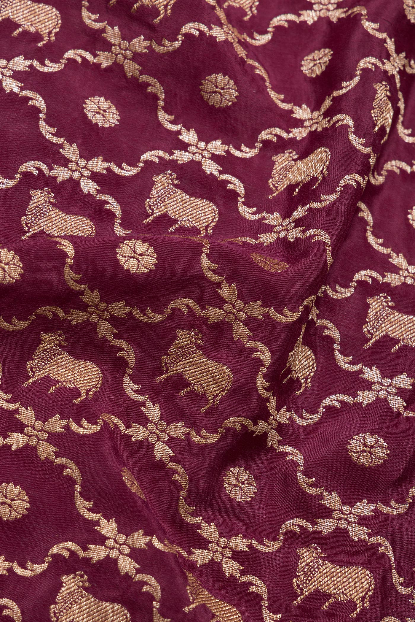 Close up of Maroon Dual Tone Banarasi Georgette Saree with Zari Brocade on the body and Zari Border.  displaying folds