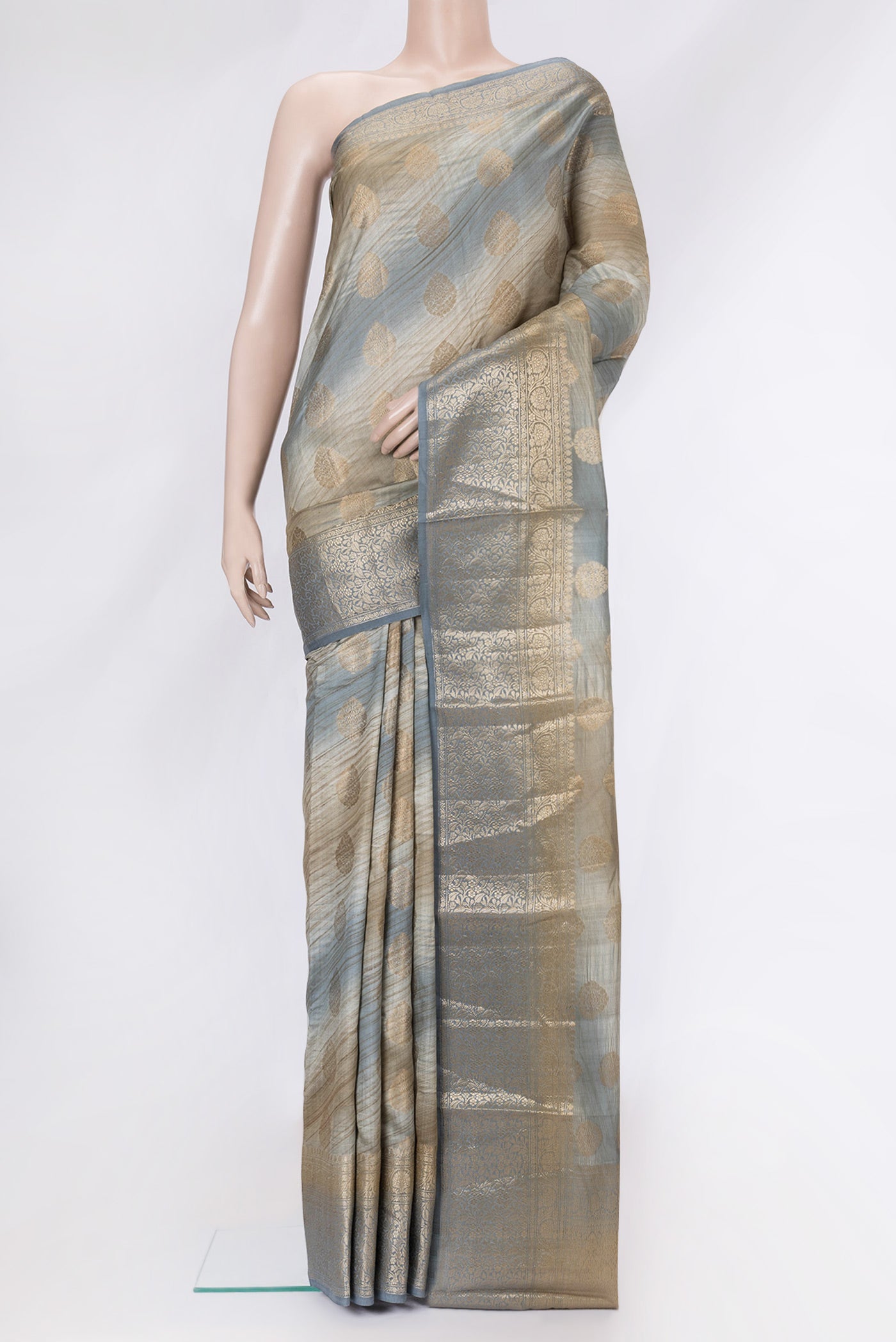 Grey Dual Tone Banarasi Raw Silk Saree with Zari Butta on the body and Zari Border.  displayed on a mannequin