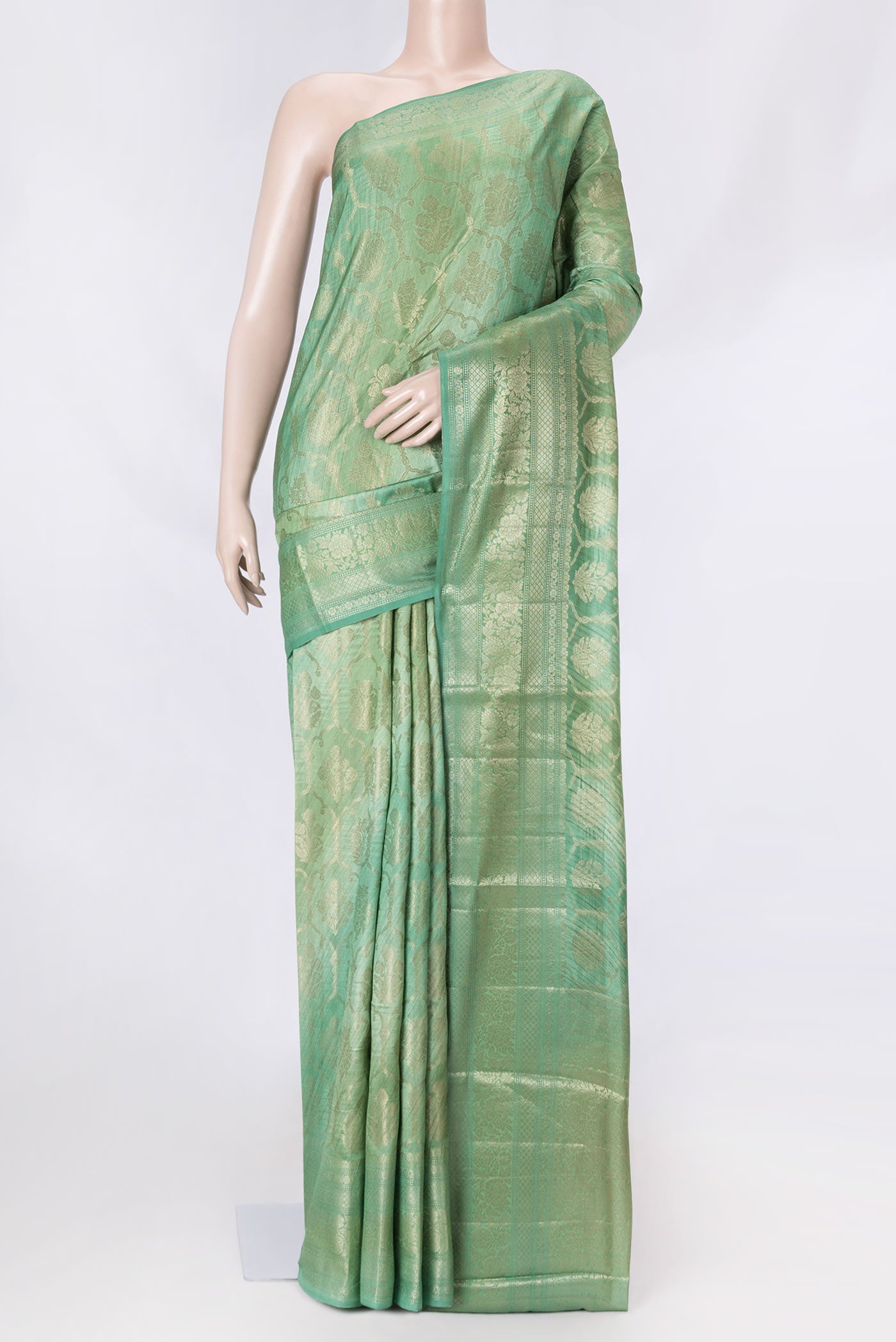 Sage Green Banarasi Raw Silk Saree with Zari Butta on the body and Zari Border displayed on a mannequin