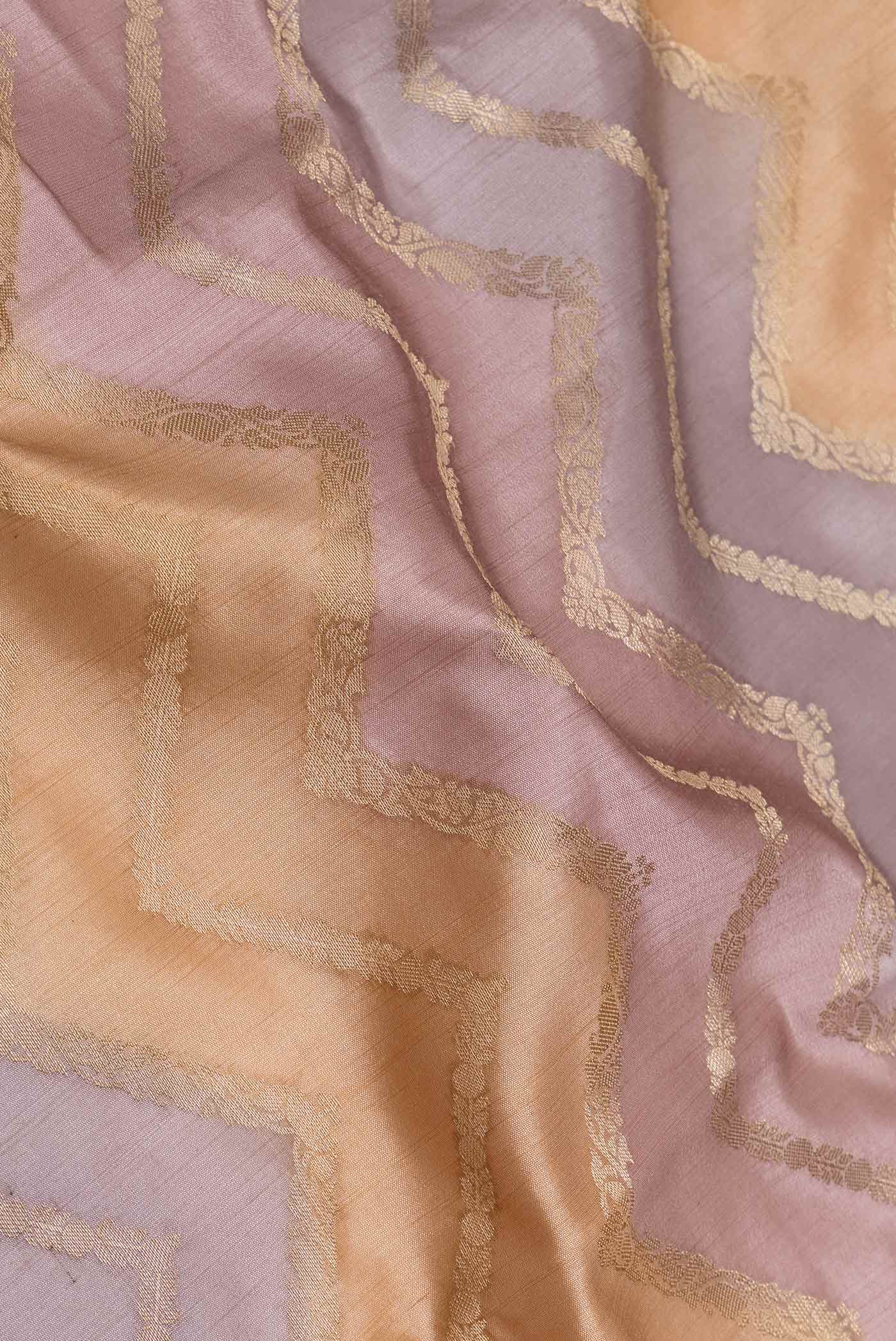 Close up of Lavender and Peach Color Banarasi Raw Silk Saree with Zig Zag design on the body and Zari Border displaying folds