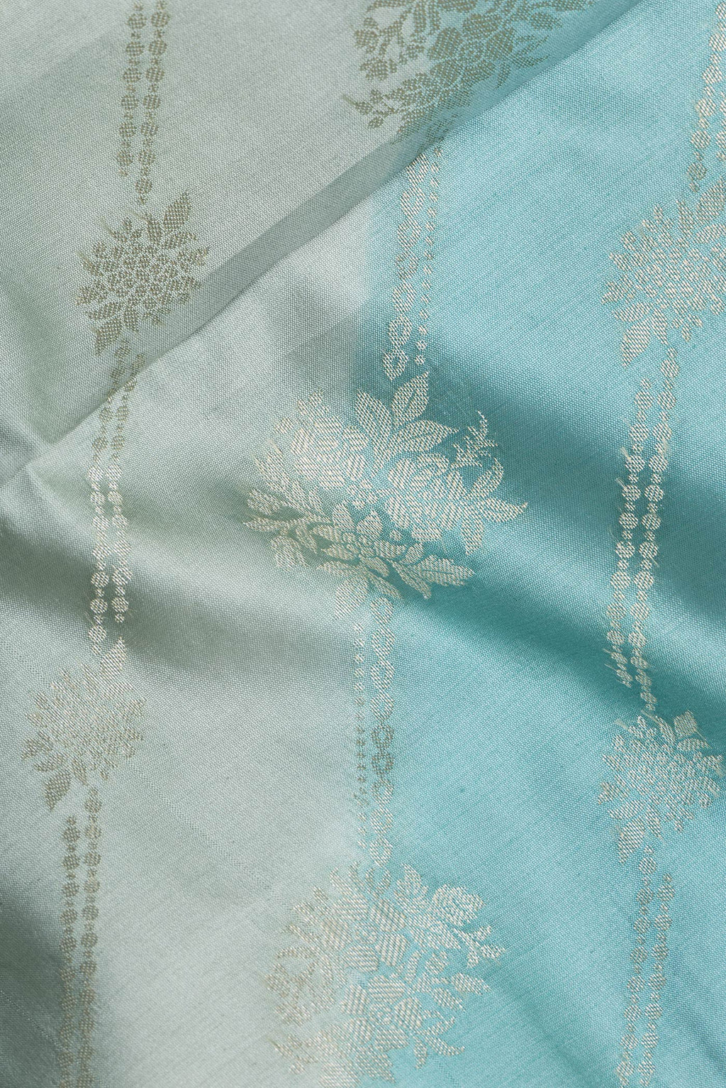 Close up of Light Blue Tussar Silk Saree with Zari Brocade on the body and Zari Border.  displaying folds