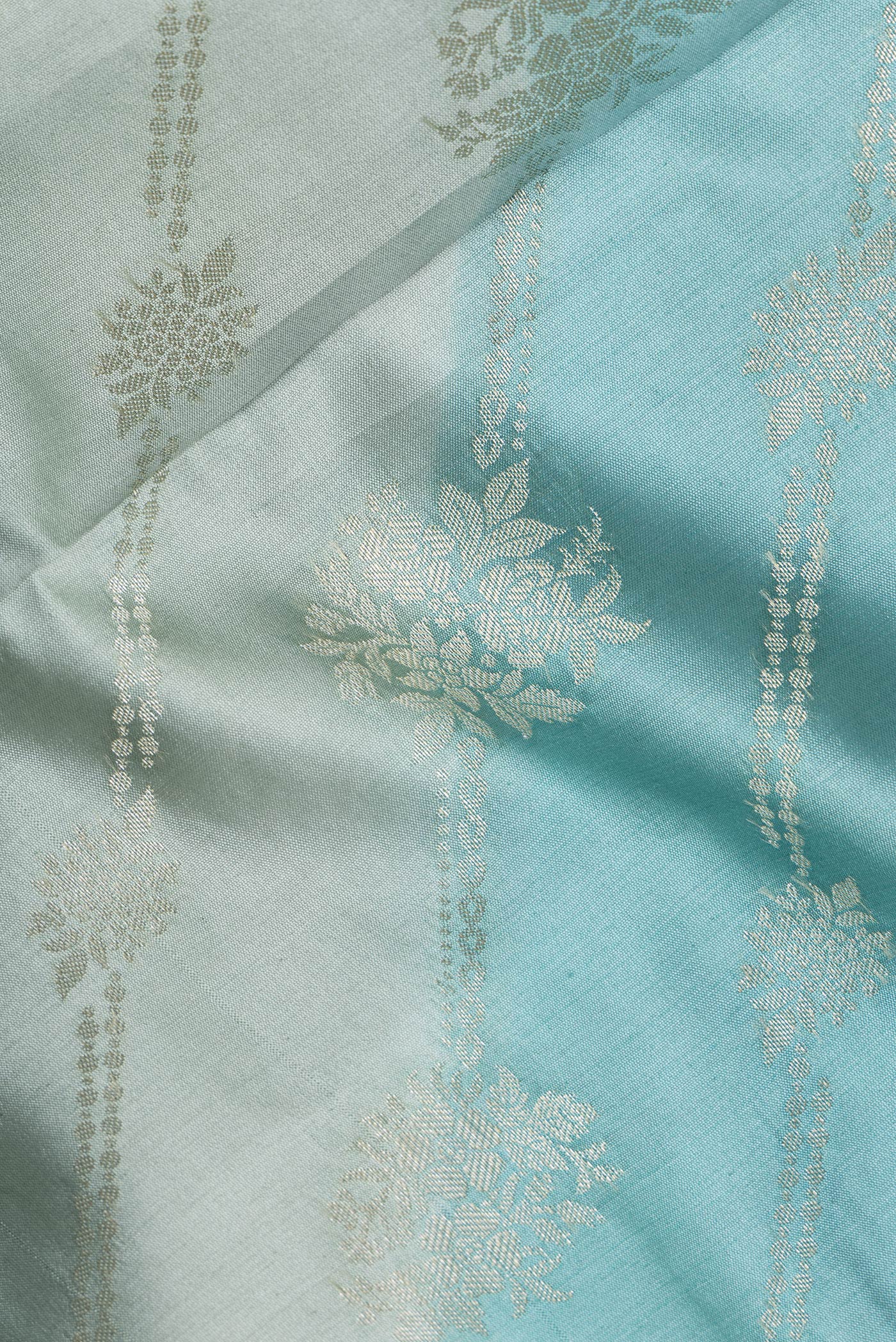 Close up of Light Blue Tussar Silk Saree with Zari Brocade on the body and Zari Border.  displaying folds