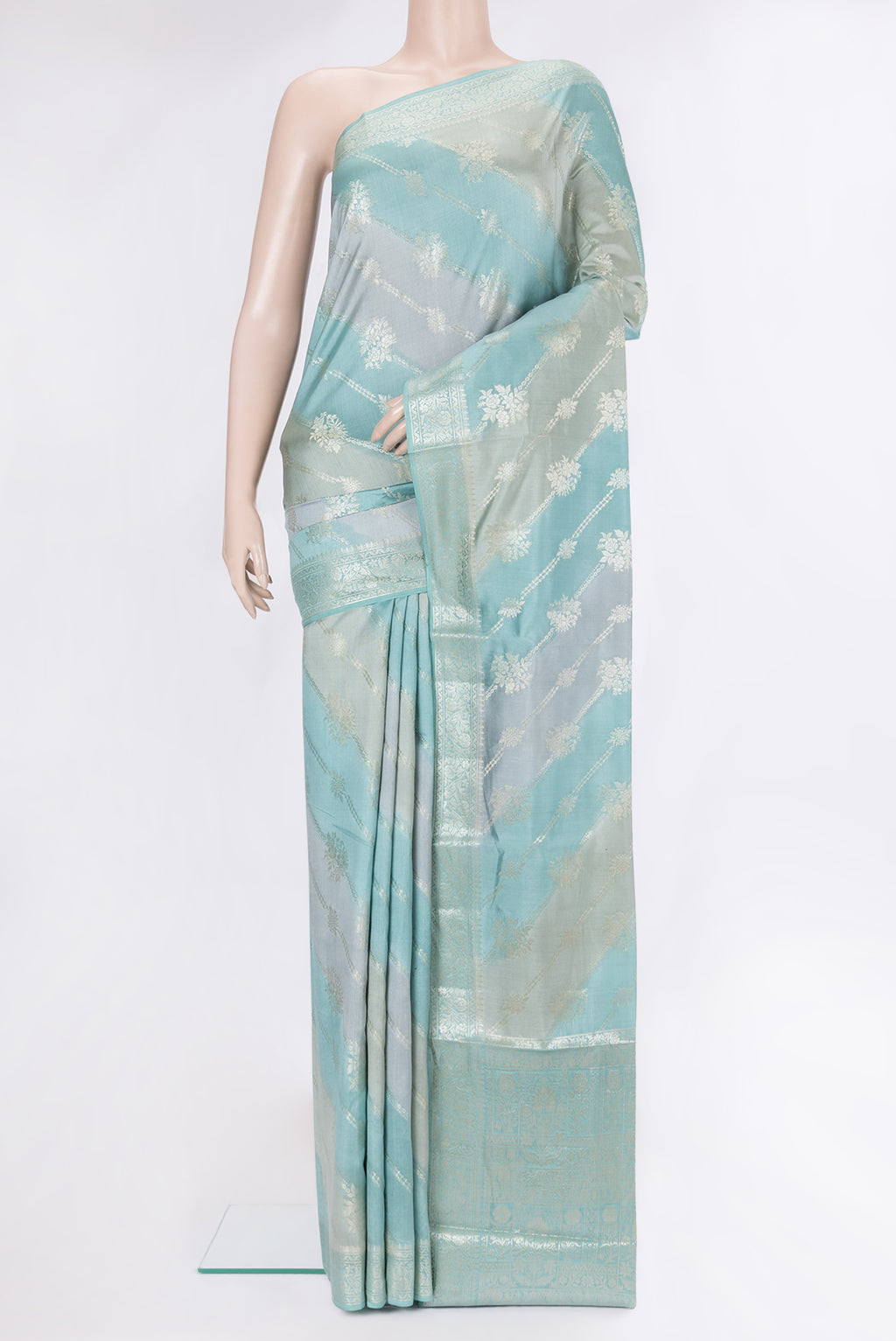 Light Blue Tussar Silk Saree with Zari Brocade on the body and Zari Border.  displayed on a mannequin