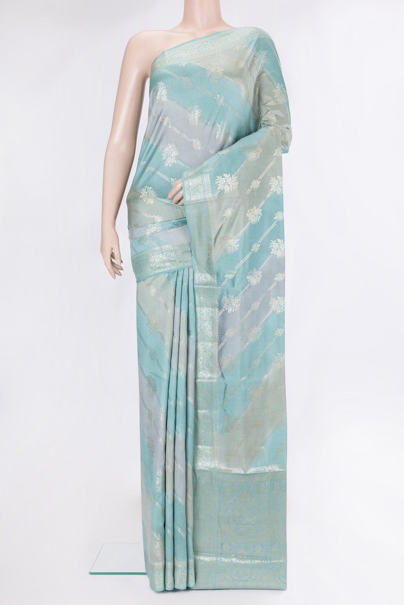 Light Blue Tussar Silk Saree with Zari Brocade on the body and Zari Border.  displayed on a mannequin