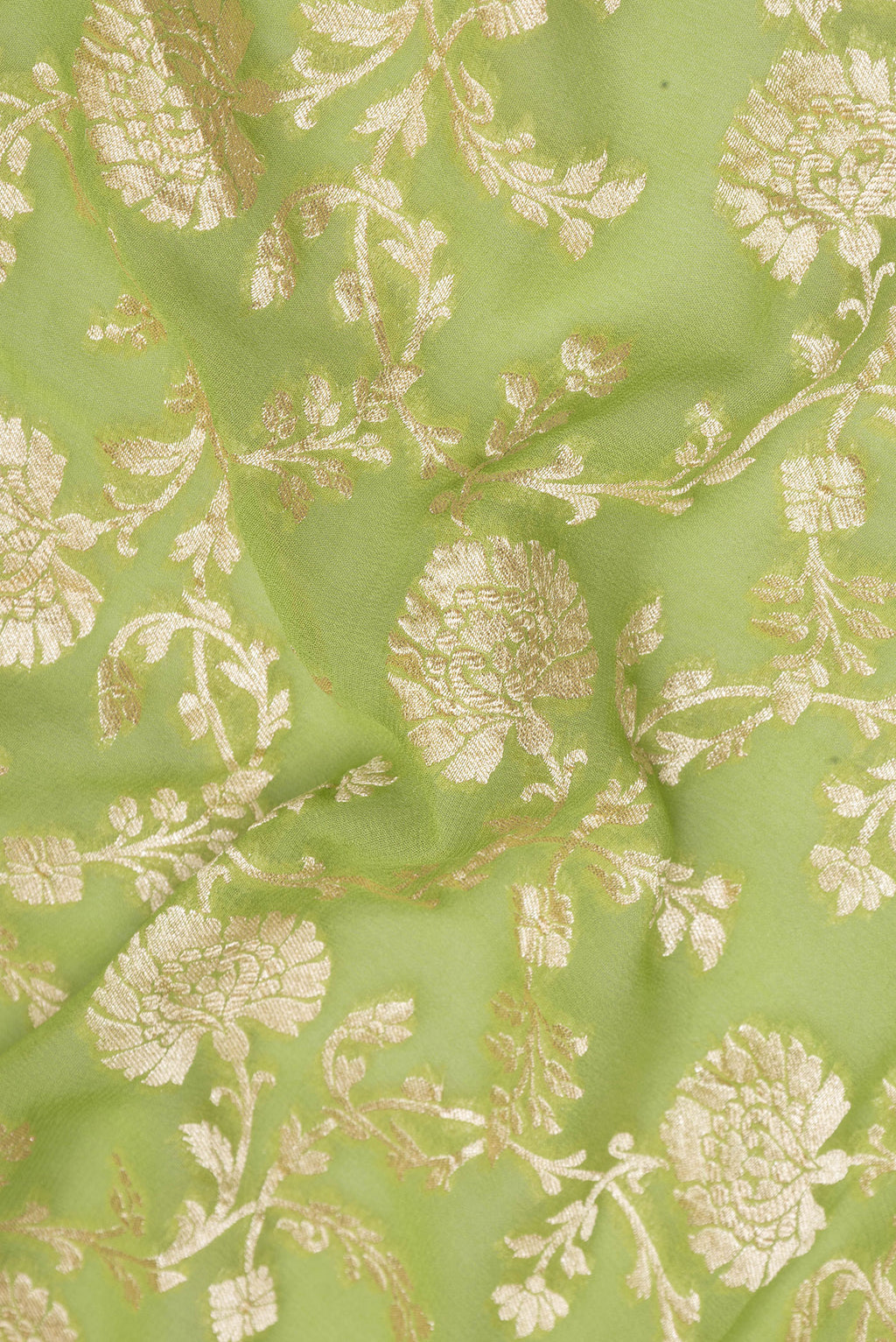 Close up of Light Green Banarasi Georgette Saree with Zari Brocade on the body and Zari Border.  displaying folds