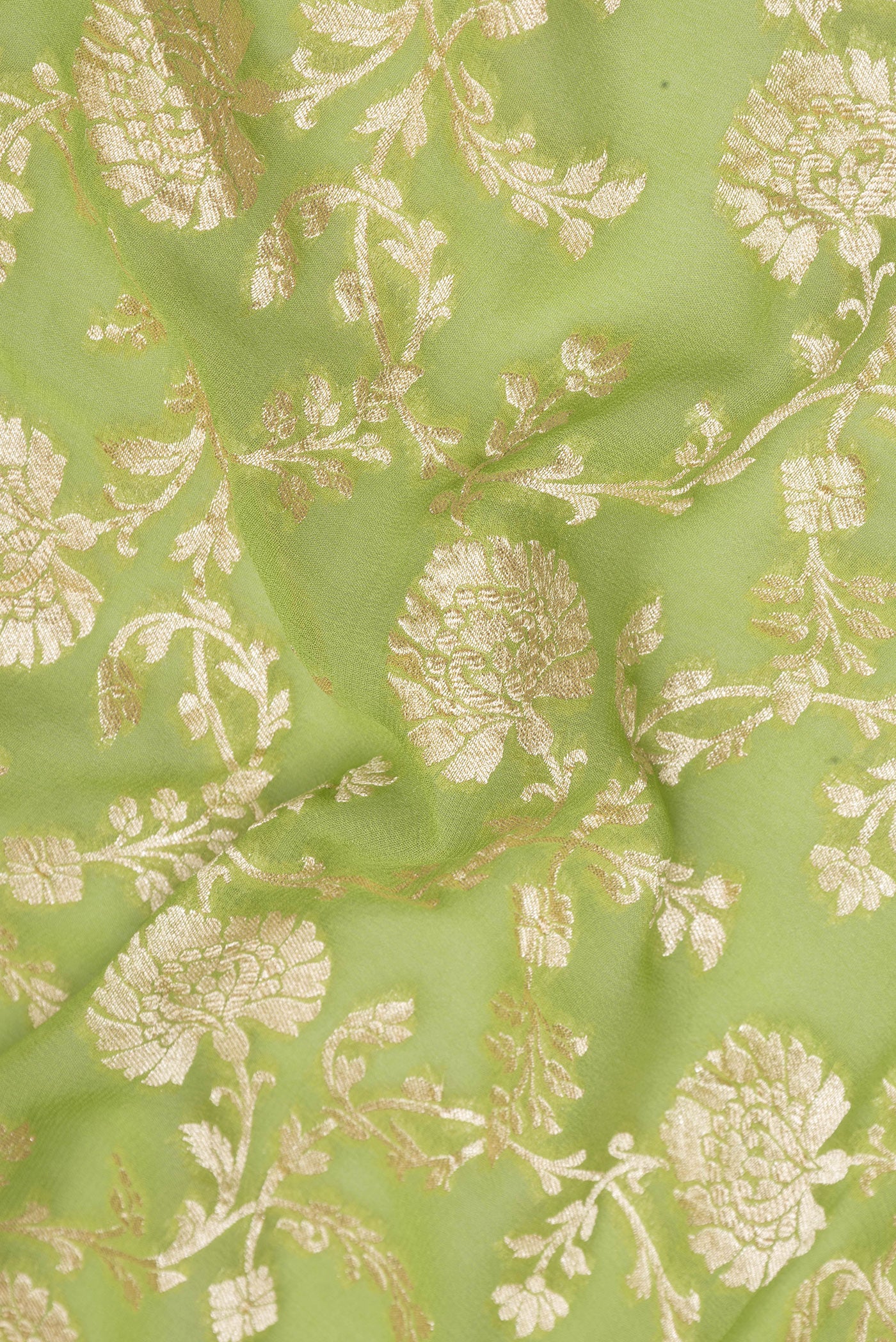 Close up of Light Green Banarasi Georgette Saree with Zari Brocade on the body and Zari Border.  displaying folds