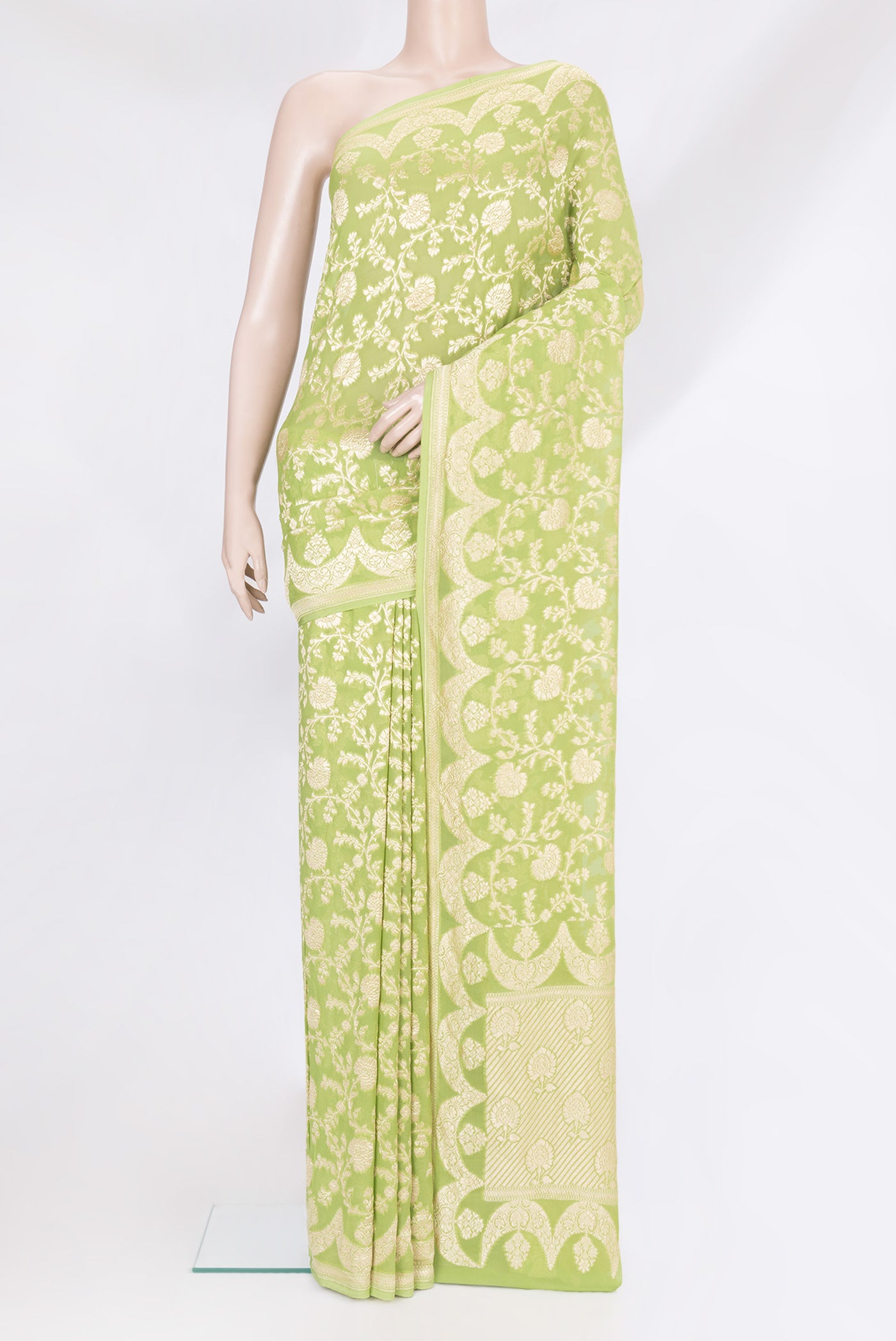 Light Green Banarasi Georgette Saree with Zari Brocade on the body and Zari Border.  displayed on a mannequin