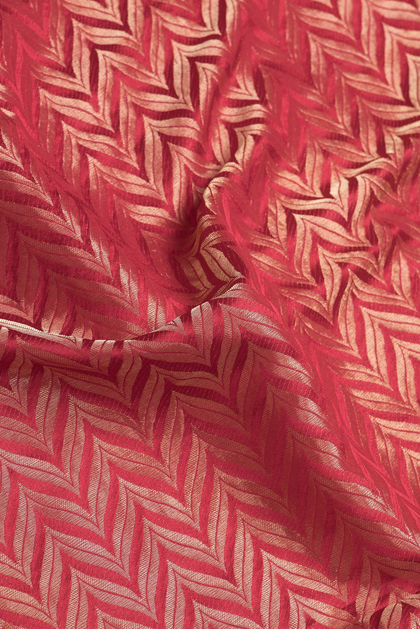 Close up of Red Dual Tone Mysore Georgette Saree with Zari Brocade on the body and Zari Border.  displaying folds