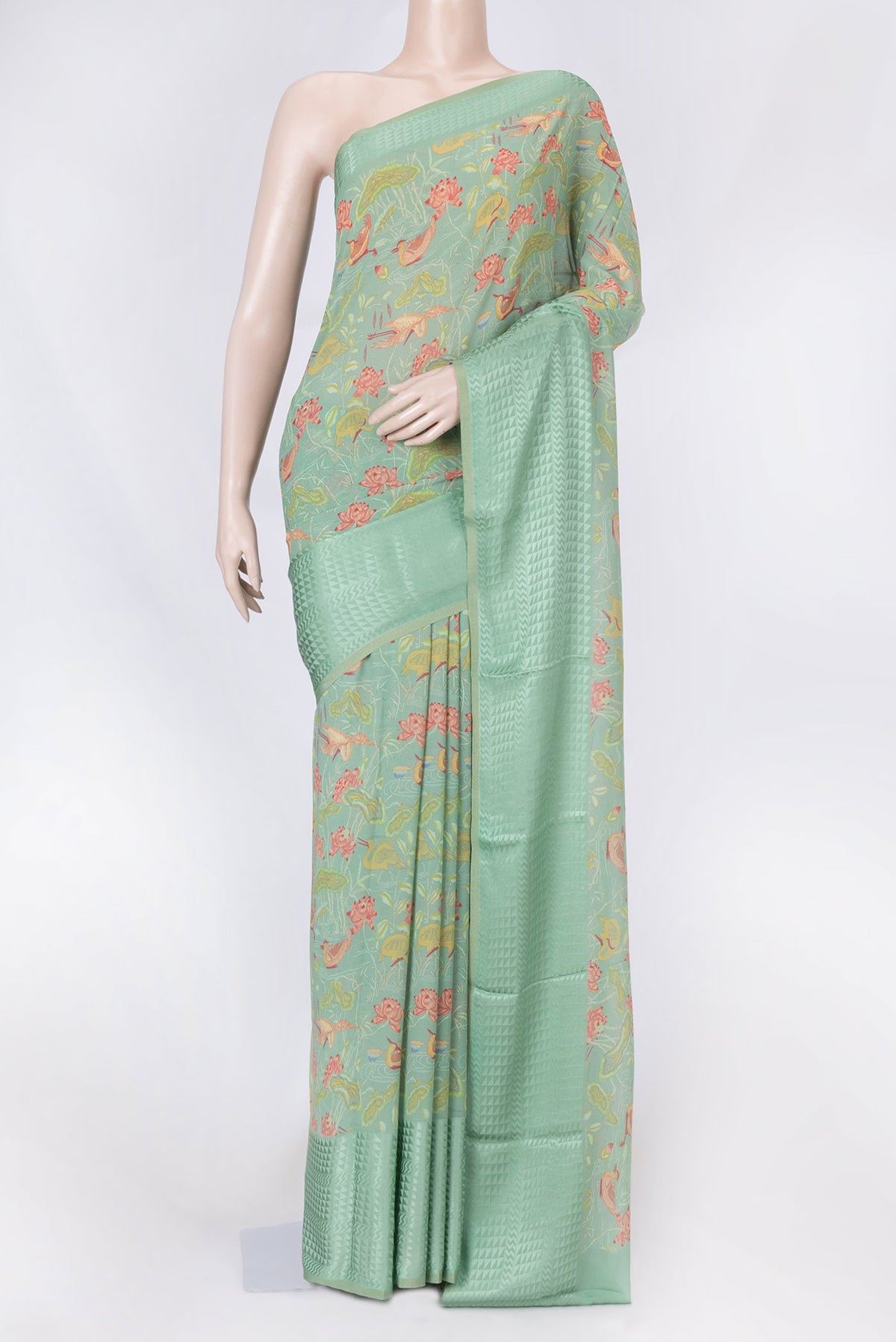 Green Dual Tone Mysore Georgette Saree with Printed design on the body and Thin Zari Line displayed on a mannequin