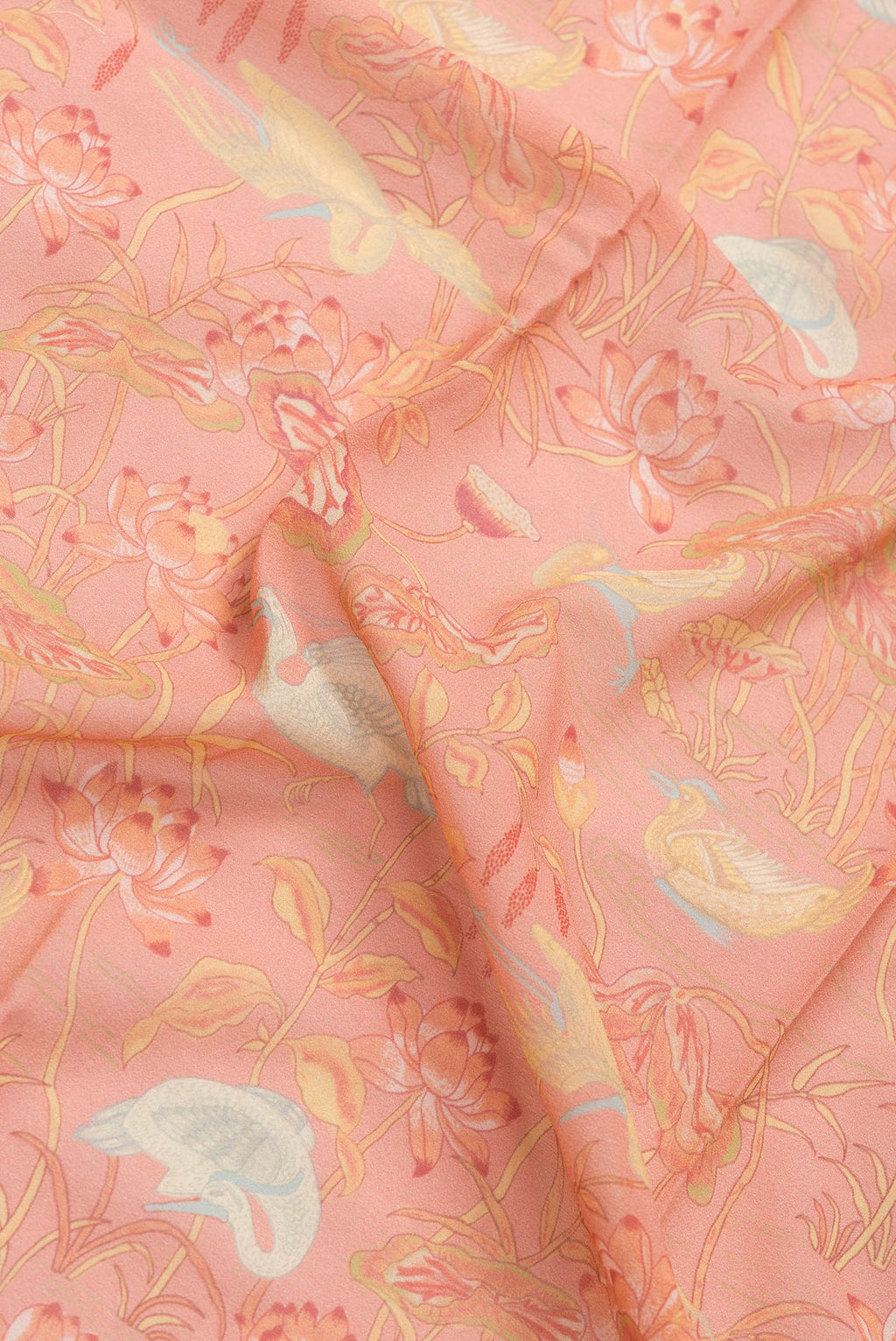Close up of Peach Dual Tone Georgette Saree with Printed design on the body and Zari Border.  displaying folds