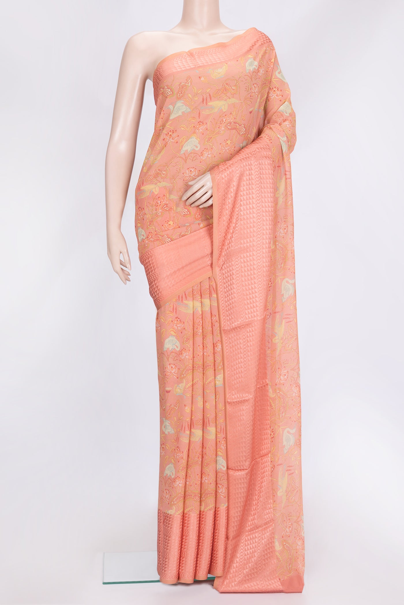 Peach Dual Tone Georgette Saree with Printed design on the body and Zari Border.  displayed on a mannequin