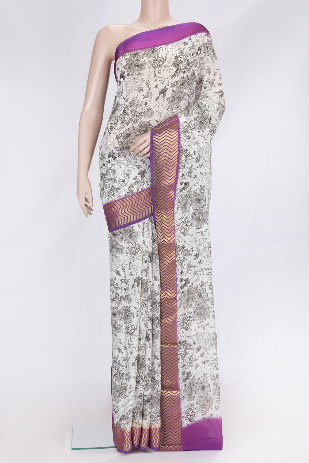 Off White Dual Tone Mysore Georgette Saree with Printed design on the body and Zari Border.  displayed on a mannequin