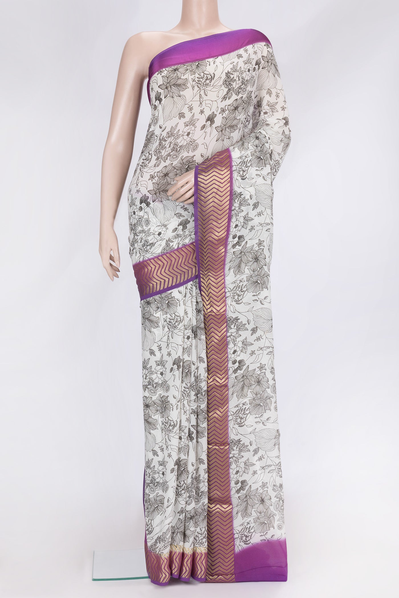 Off White Dual Tone Mysore Georgette Saree with Printed design on the body and Zari Border.  displayed on a mannequin