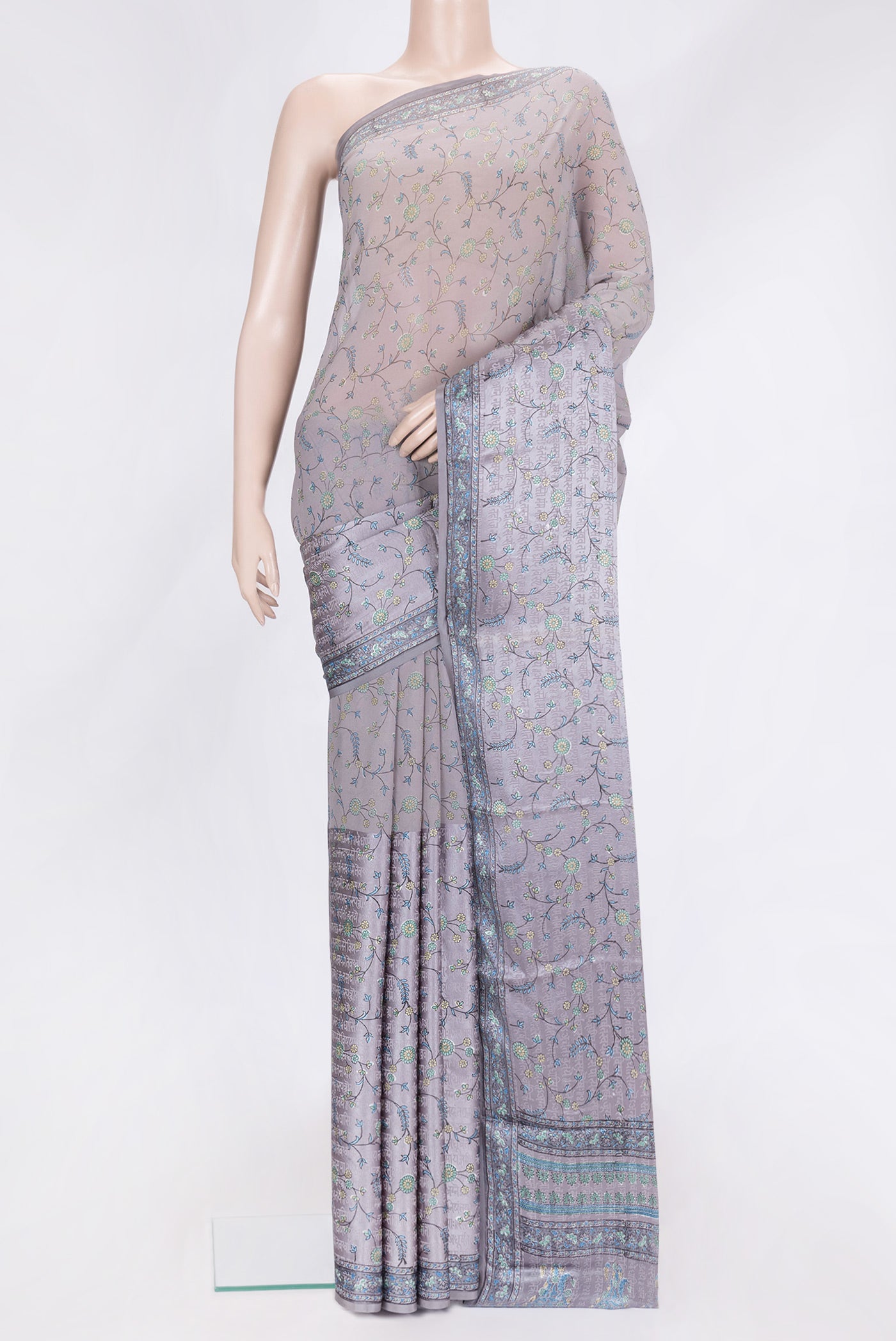 Grey Dual Tone Mysore Georgette Saree with Printed design on the body and Printed Border.  displayed on a mannequin