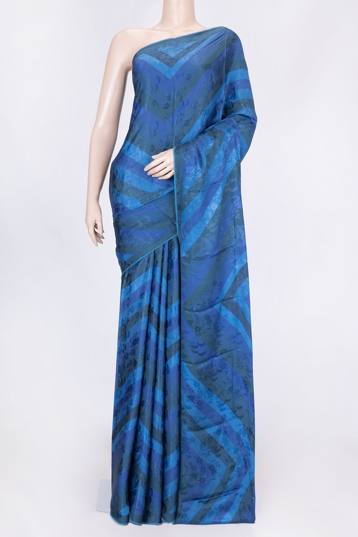 Blue Dual Tone Mysore Crepe Saree with Printed design on the body and Embroidery Border displayed on a mannequin