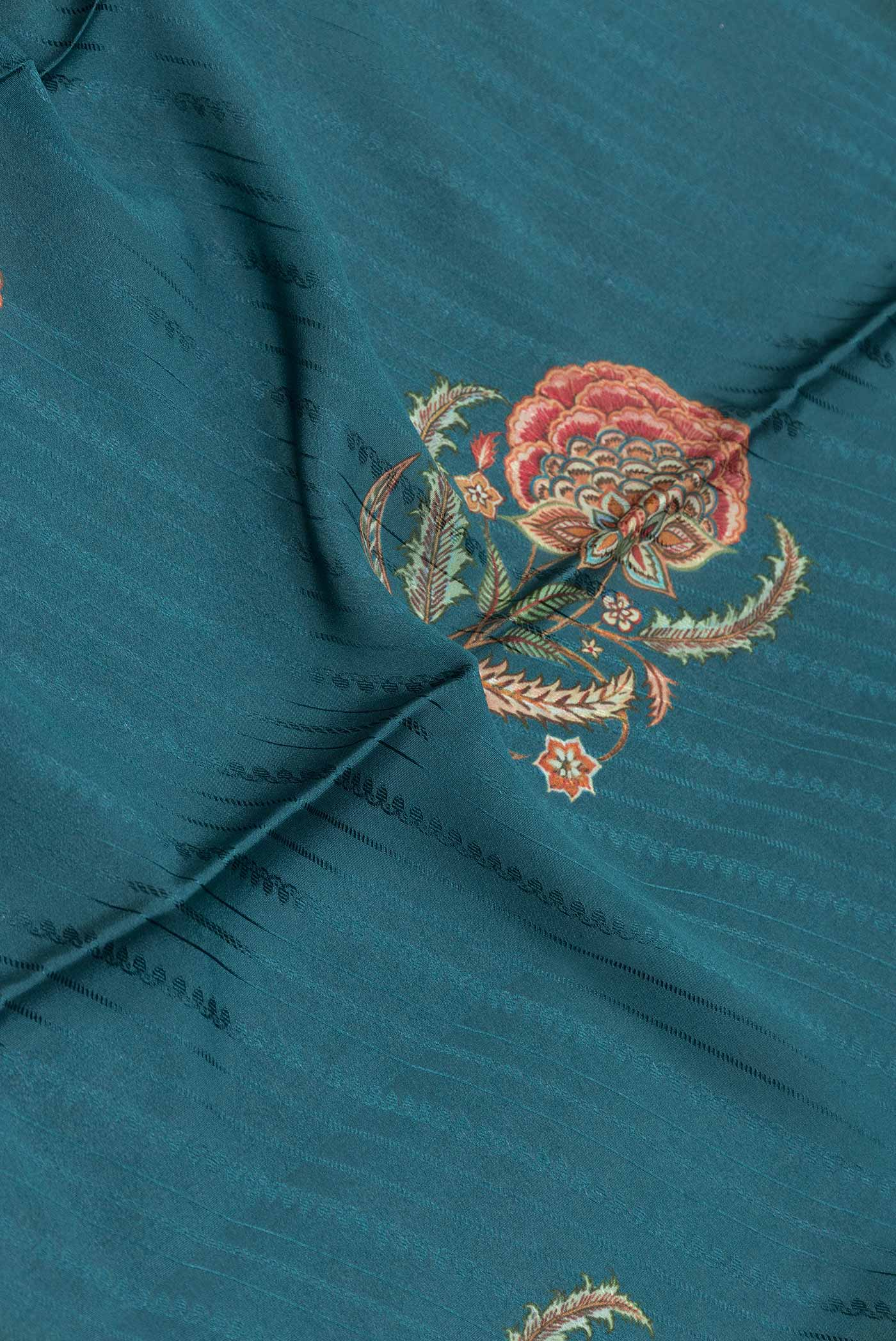 Close up of Green Dual Tone Tussar Silk Saree with Printed design on the body and Zari Border displaying folds