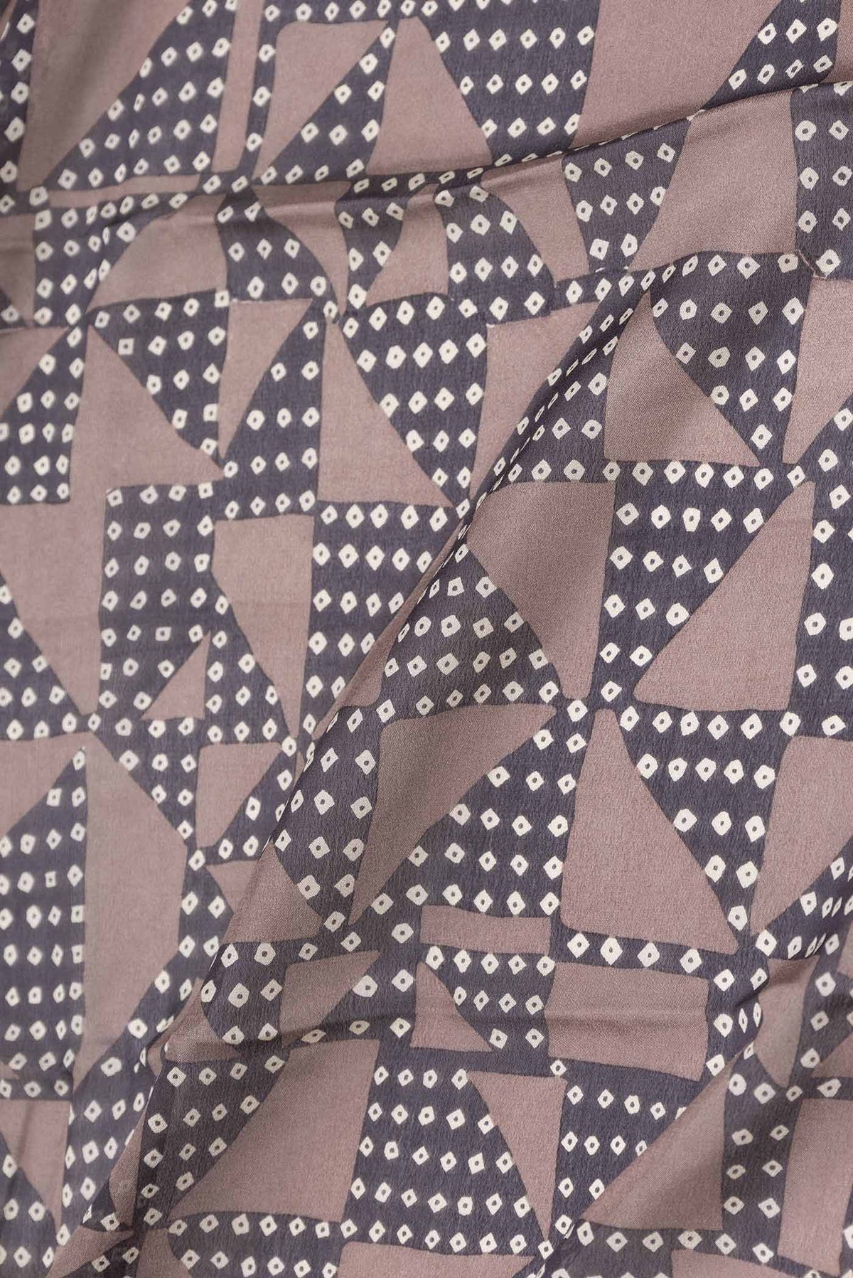 Close up of Brown Dual Tone Tussar Silk Saree with Printed design on the body and Zari Border displaying folds