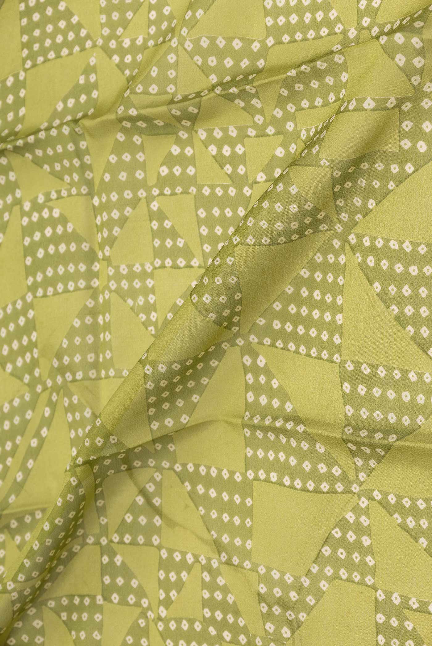 Close up of Green Mysore Crepe Saree with Printed design on the body and Zari Border displaying folds