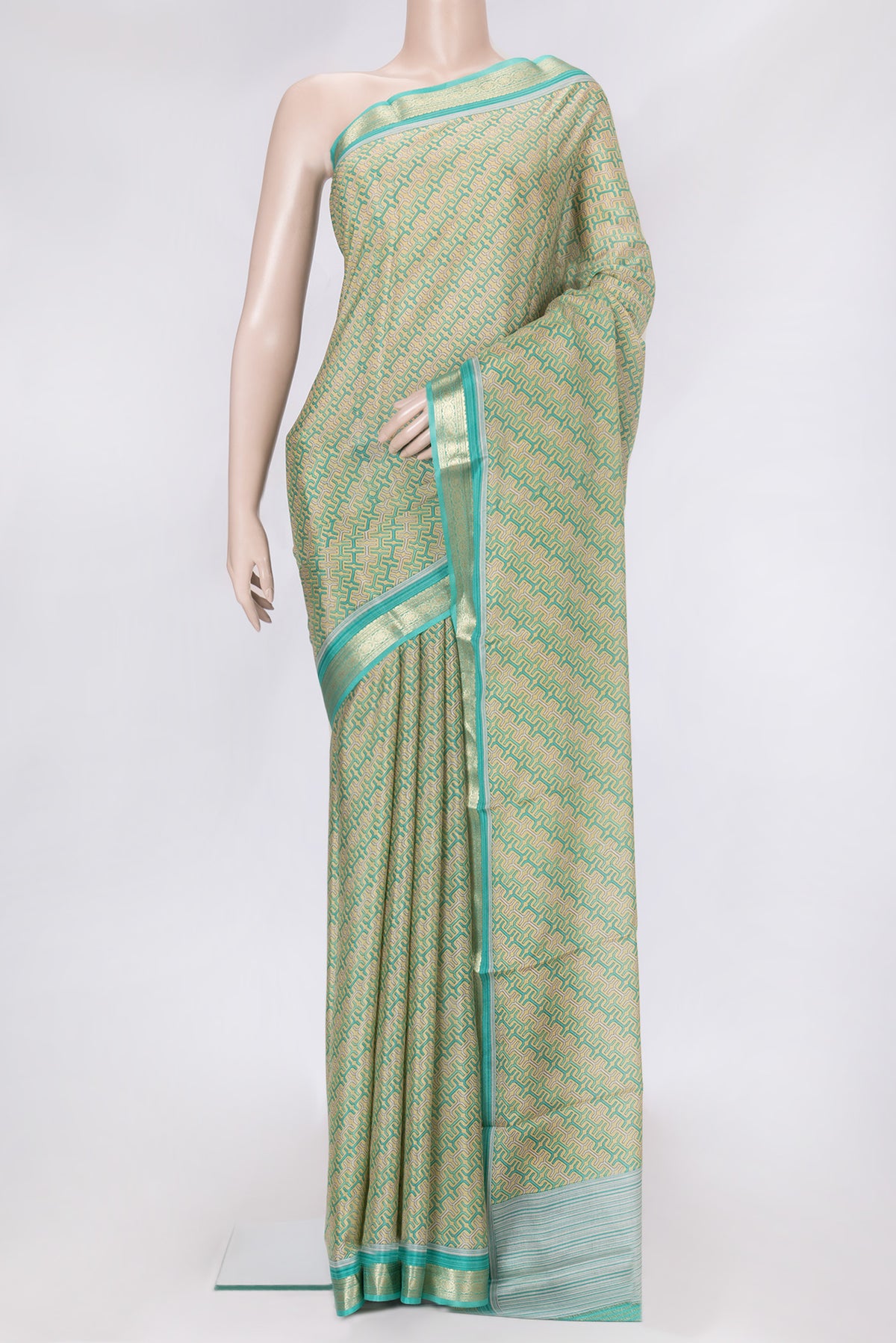 Sandal Dual Tone Mysore Crepe Saree with Printed design on the body and Zari Border.  displayed on a mannequin