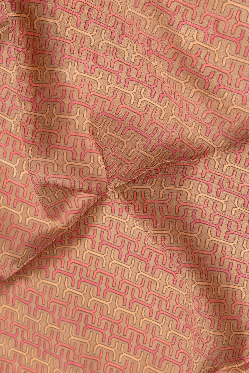 Close up of Brown Dual Tone Mysore Crepe Saree with Printed design on the body and Zari Border.  displaying folds