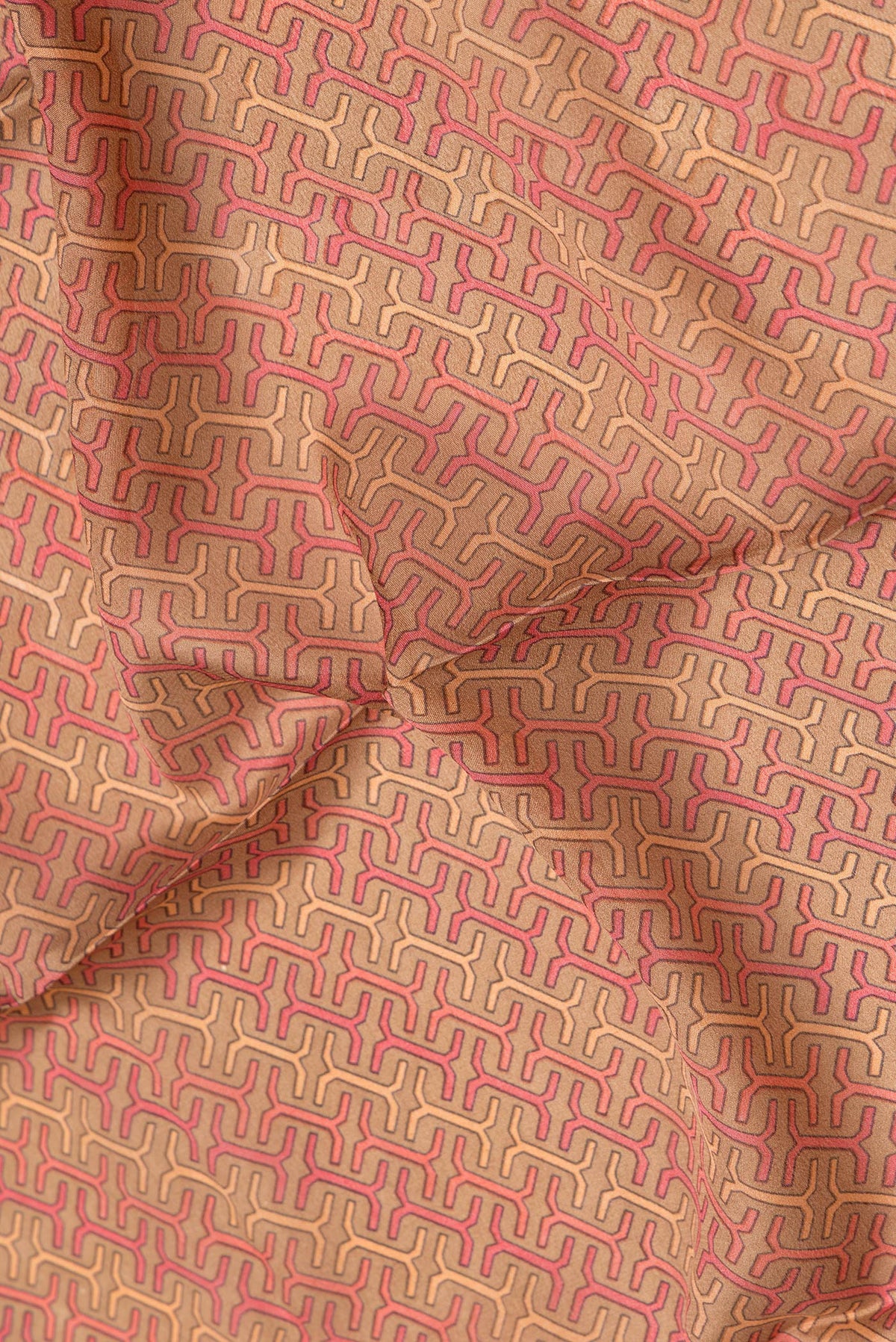 Close up of Brown Dual Tone Mysore Crepe Saree with Printed design on the body and Zari Border.  displaying folds