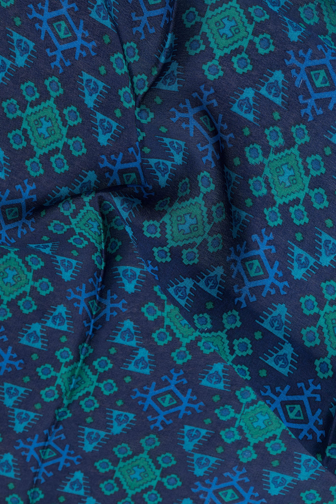 Close up of Navy Blue Dual Tone Crepe Saree with Printed design on the body and Zari Border.  displaying folds