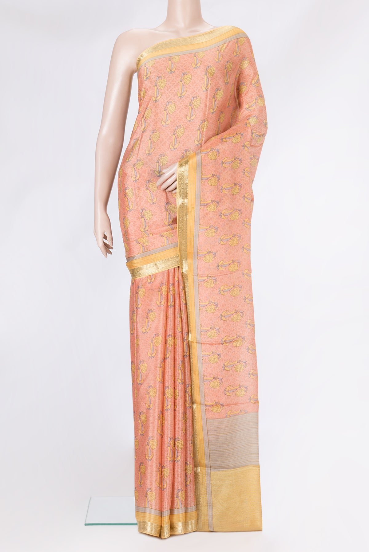 Peach Dual Tone Crepe Saree with Printed design on the body and Zari Border.  displayed on a mannequin
