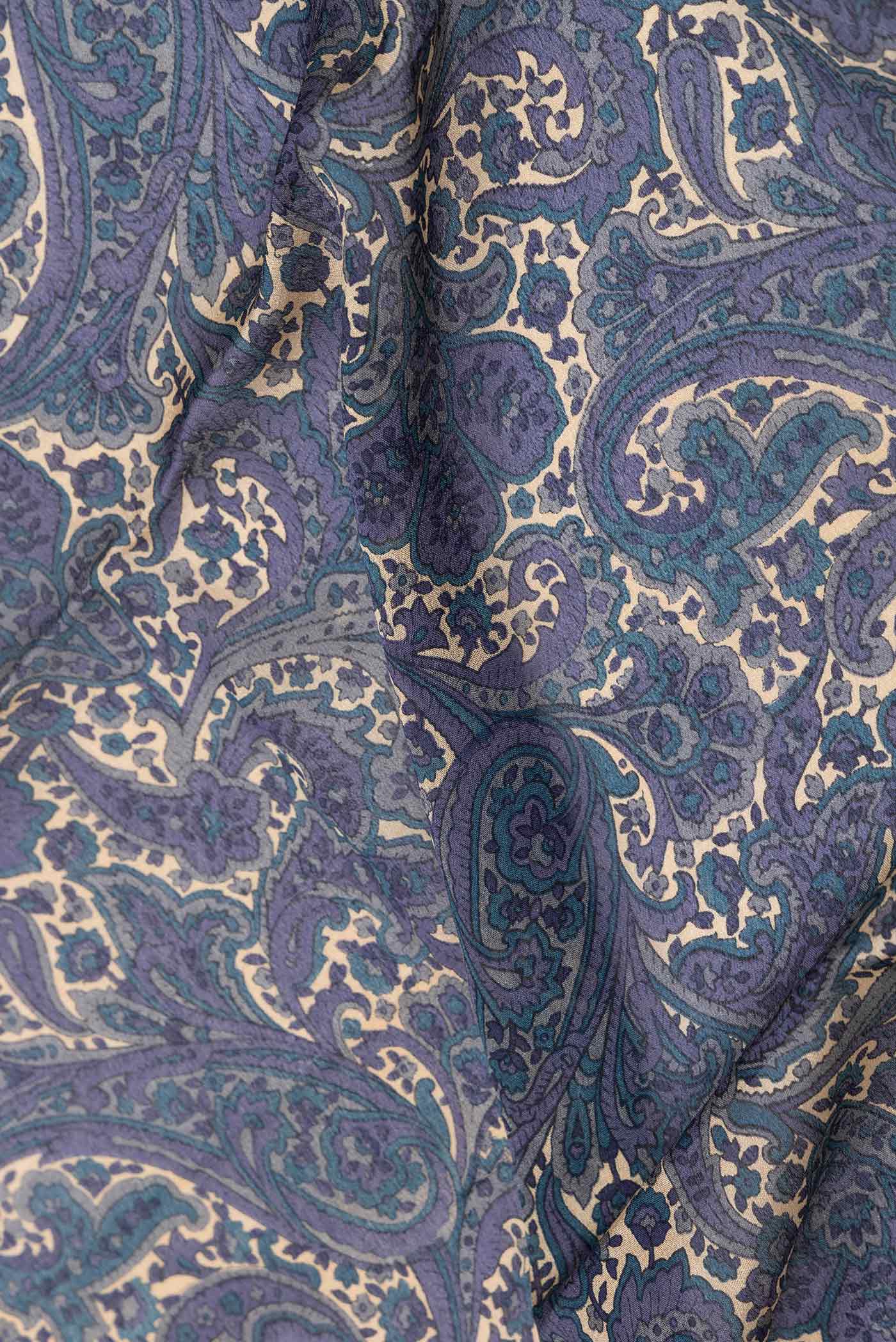Close up of Blue Grey Dual Tone Mysore Crepe Saree with Printed design on the body and Zari Border displaying folds