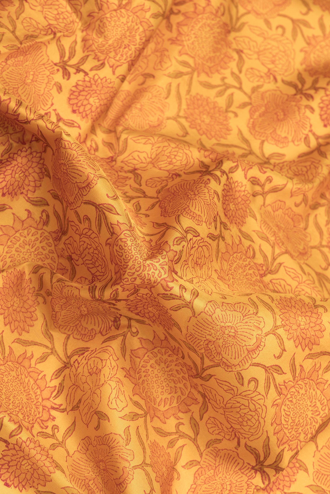 Close up of Mustard Dual Tone Kanchipuram Silk Saree with Printed design on the body and Zari Border.  displaying folds