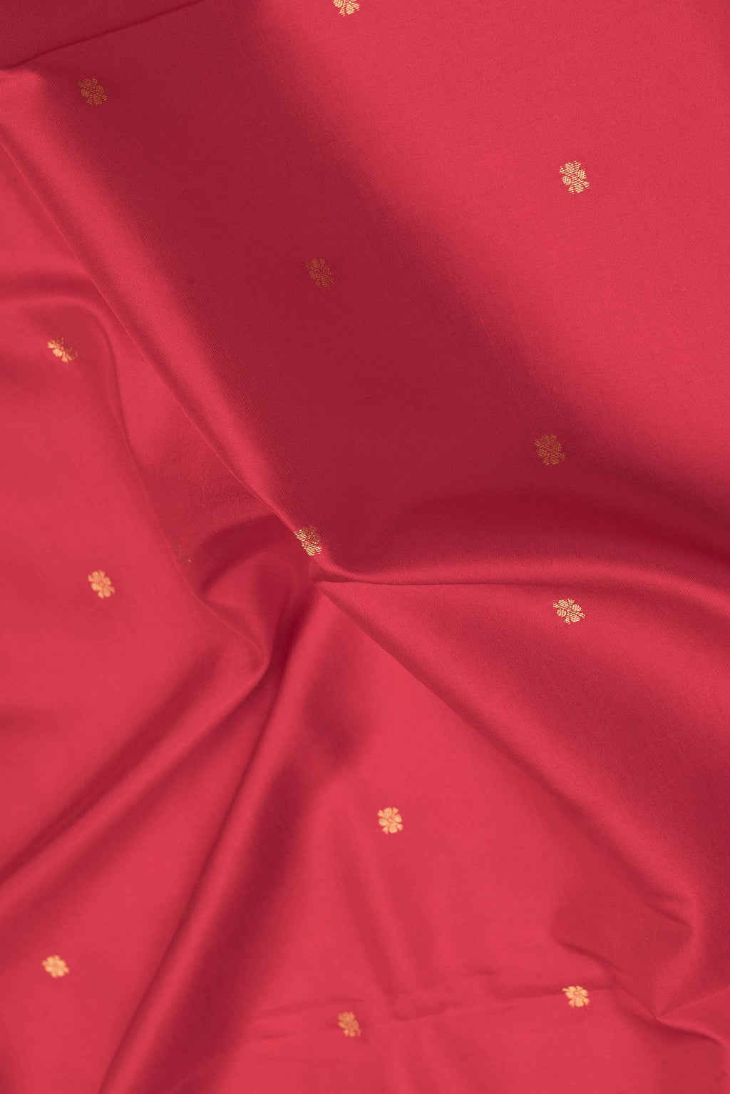 Close up of Red Kanchipuram Silk Saree with Zari Butta on the body and Printed Border.  displaying folds