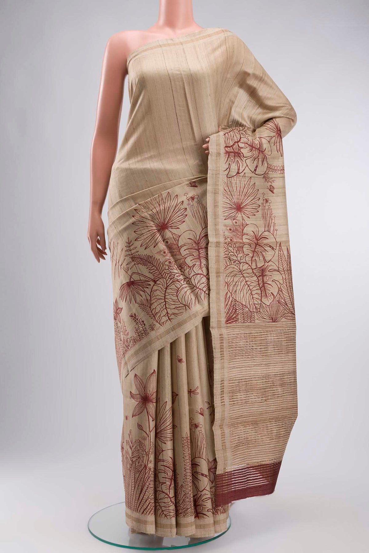 Cream Bhagalpuri Tussar Silk Saree with Printed design on the body and Zari Border displayed on a mannequin