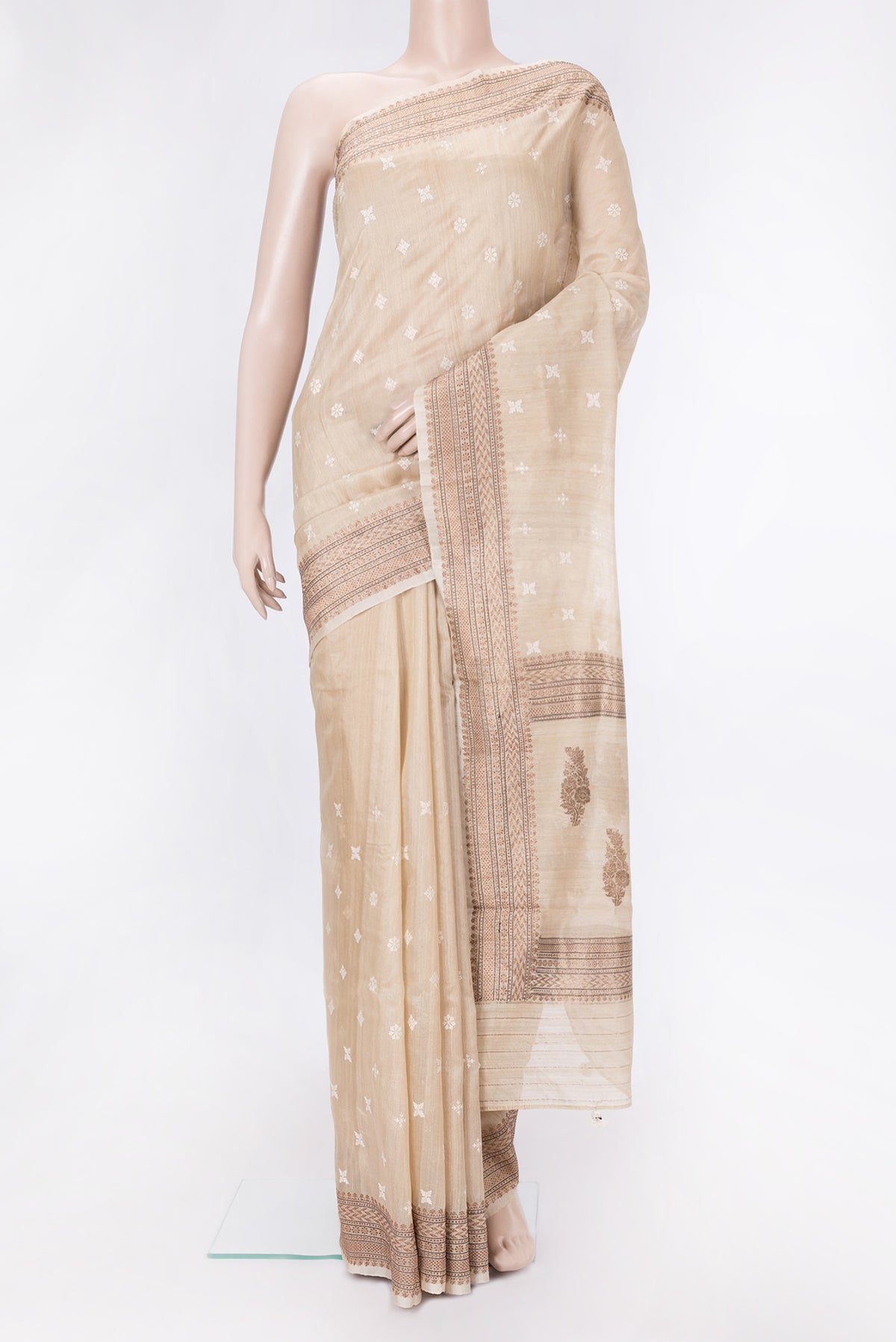 Beige Dual Tone Tussar Silk Saree with Embroidery on the body and Zari Border.  displayed on a mannequin