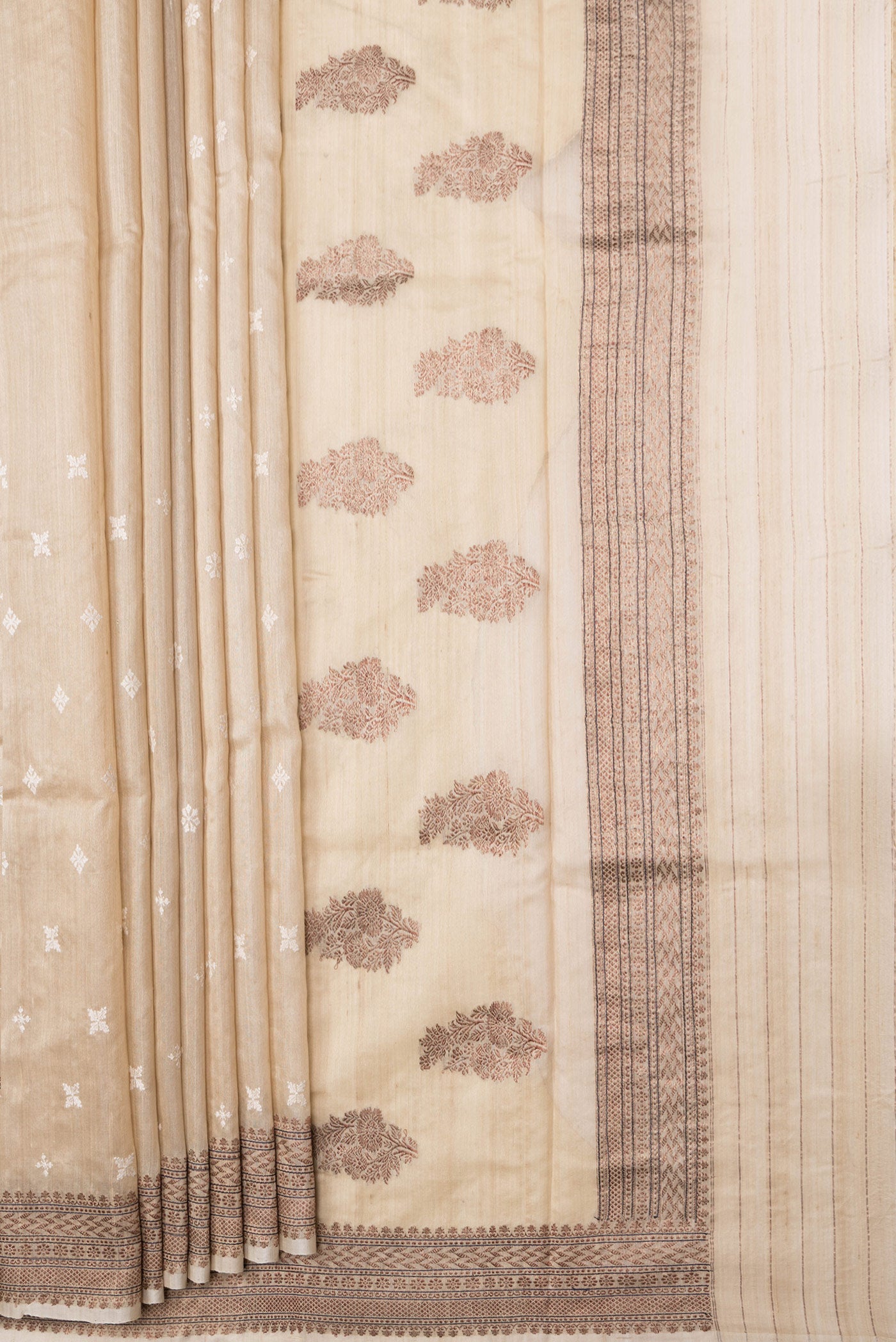 Pleats and pallu of Beige Dual Tone Tussar Silk Saree with Embroidery on the body and Zari Border. 