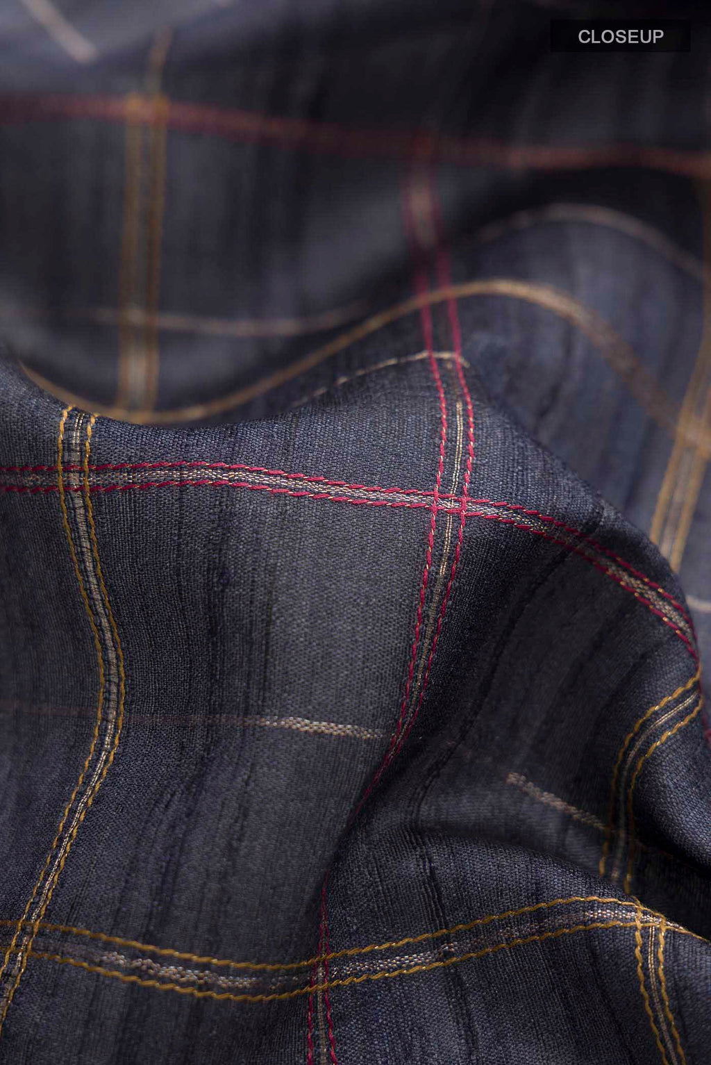 Close up of Blue Bhagalpuri Tussar Silk Saree with Checked design on the body and Embroidery Border displaying folds