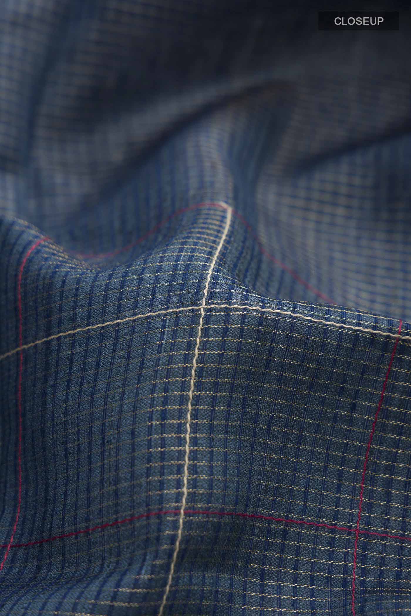 Close up of Blue Bhagalpuri Tussar Silk Saree with Stripes on the body and Zari Border displaying folds