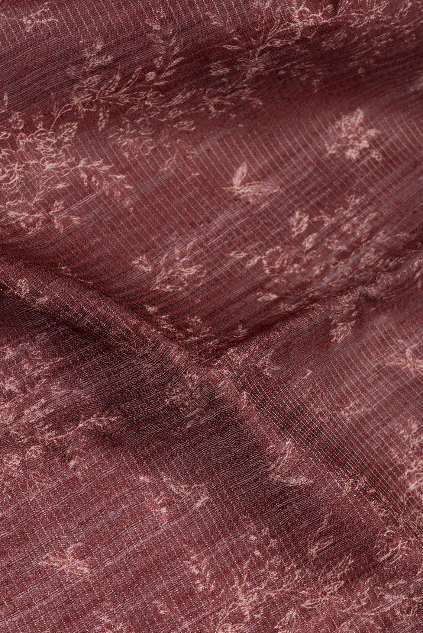 Close up of Brown Tussar Silk Saree with Printed design on the body and Zari Border.  displaying folds