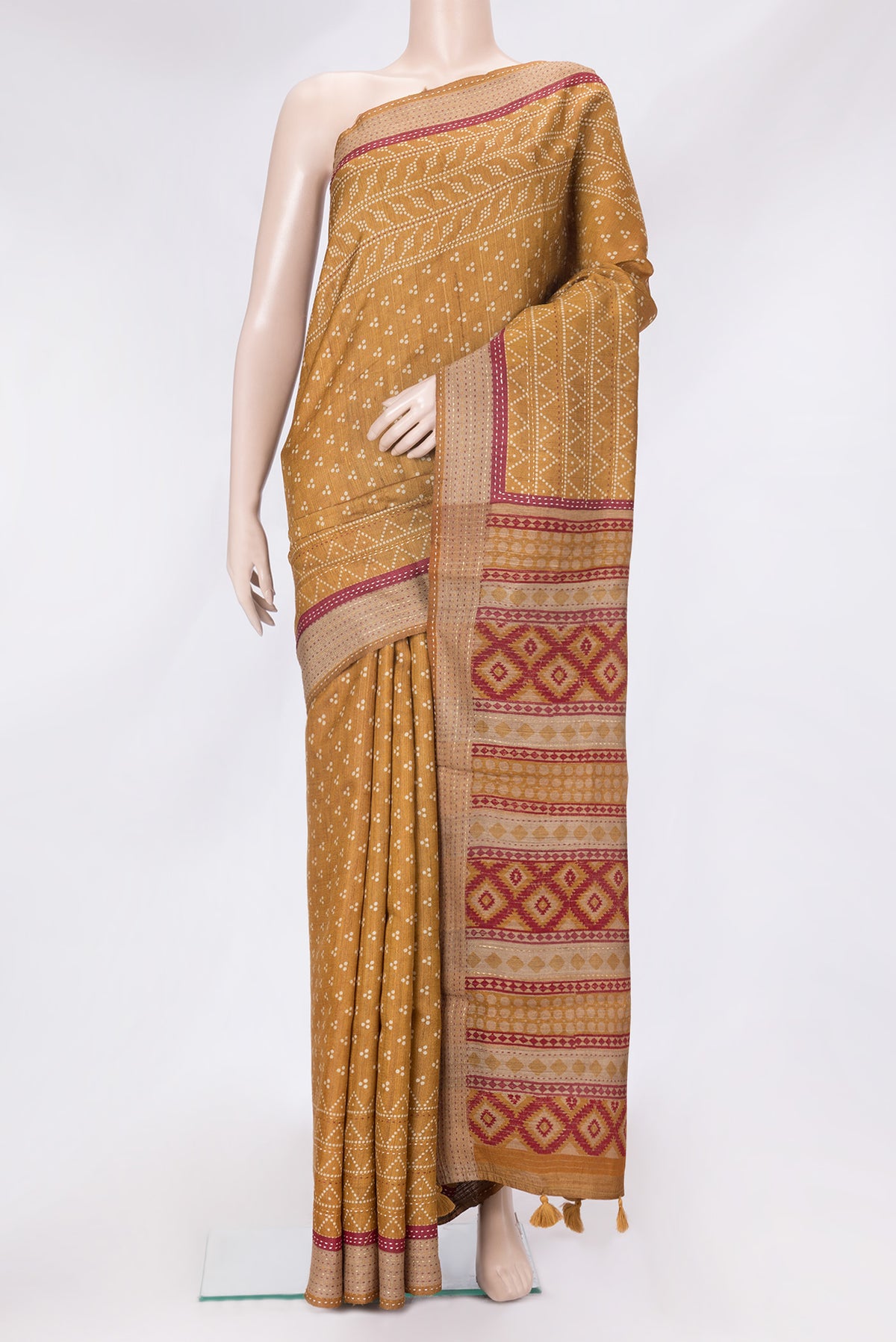 Mustard Dual Tone Tussar Silk Saree with Printed design on the body and Embroidery Border.  displayed on a mannequin