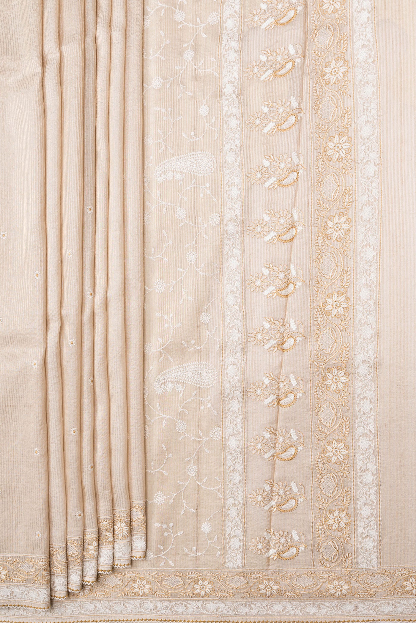 Pleats and pallu of Beige Dual Tone Tussar Silk Saree with Embroidery on the body and Embroidery Border. 