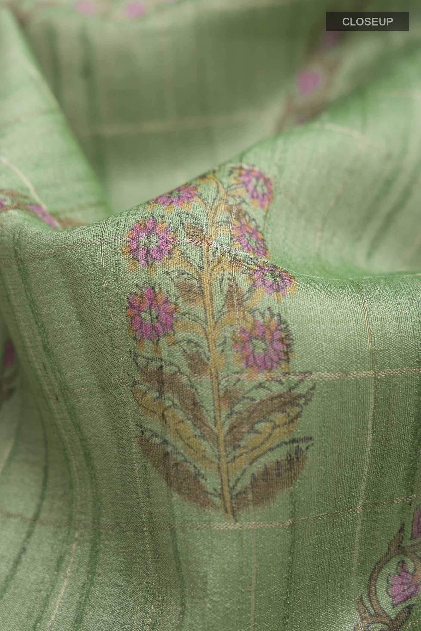 Close up of Green Tussar Silk Saree with Stripes on the body and Printed Border displaying folds