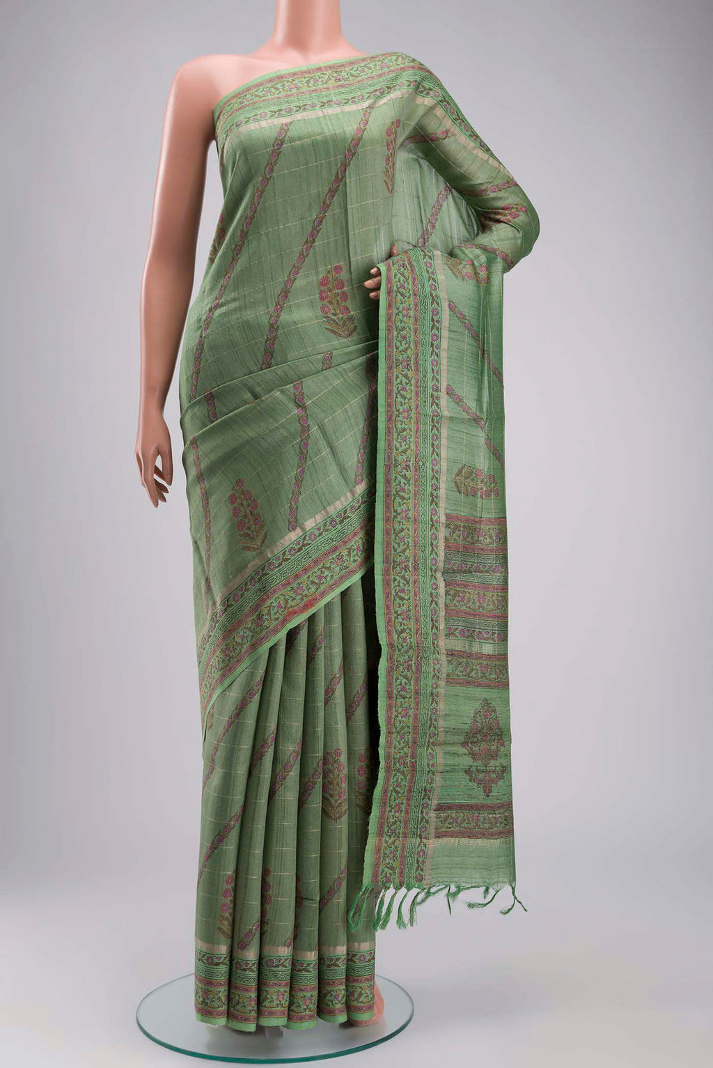 Green Tussar Silk Saree with Stripes on the body and Printed Border displayed on a mannequin