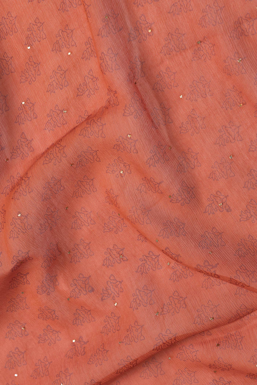 Close up of Brick Orange Dual Tone Mysore Chiffon Saree with Embroidery on the body and Embroidery Border.  displaying folds