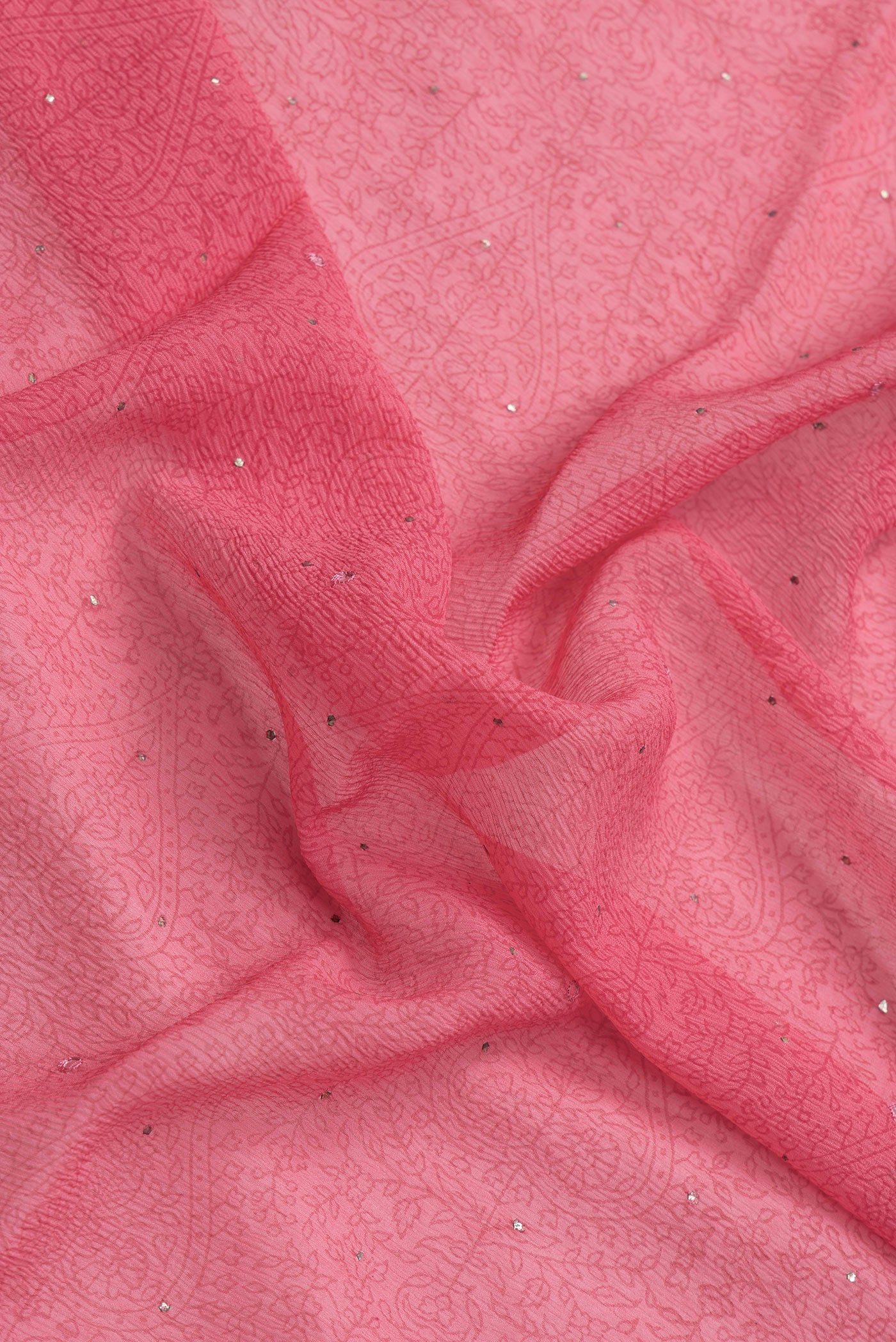 Close up of Pink Dual Tone Mysore Chiffon Saree with Printed design on the body and Embroidery Border.  displaying folds