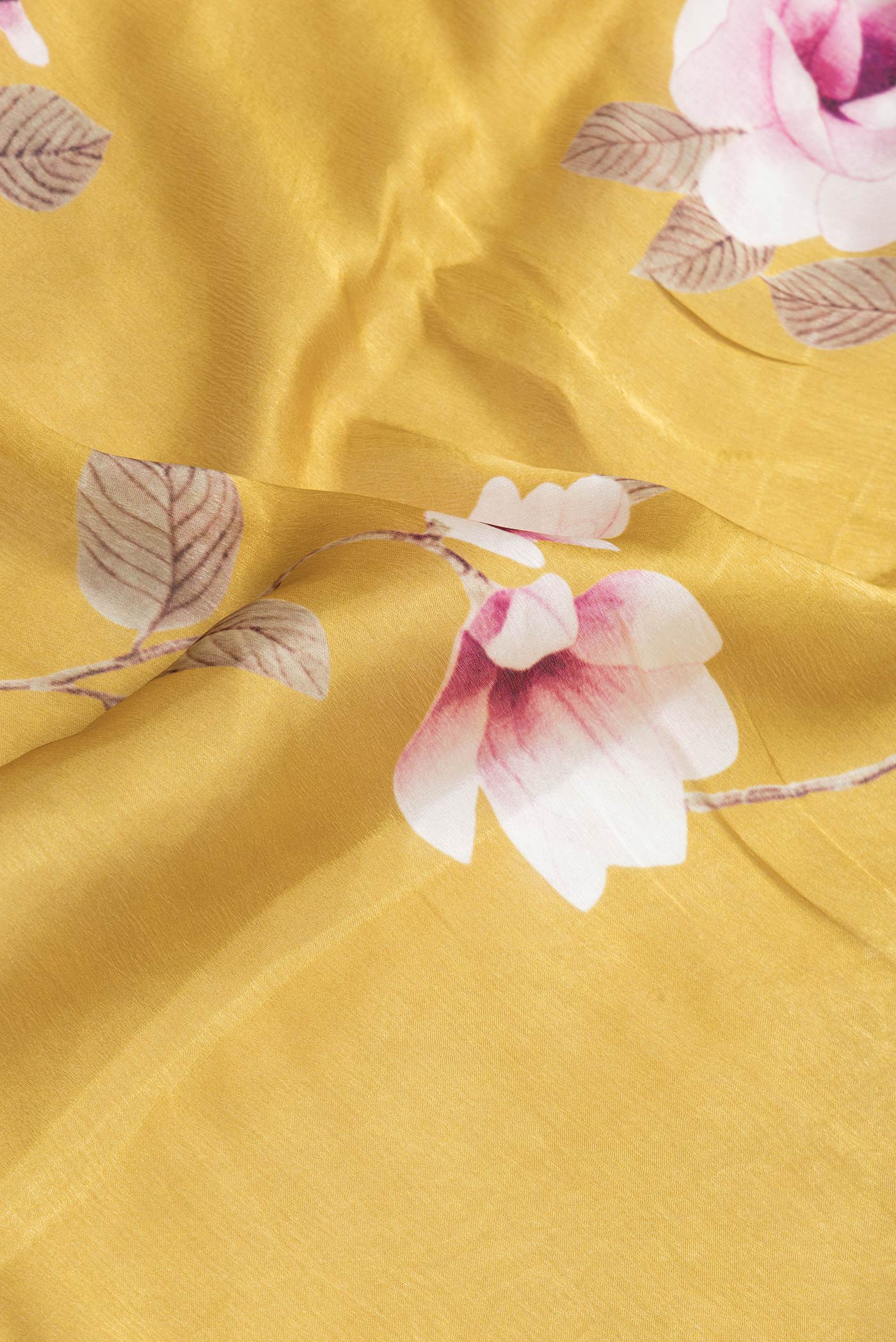 Close up of Gold Dual Tone Organza Silk Saree with Plain Body and Plain Border.  displaying folds